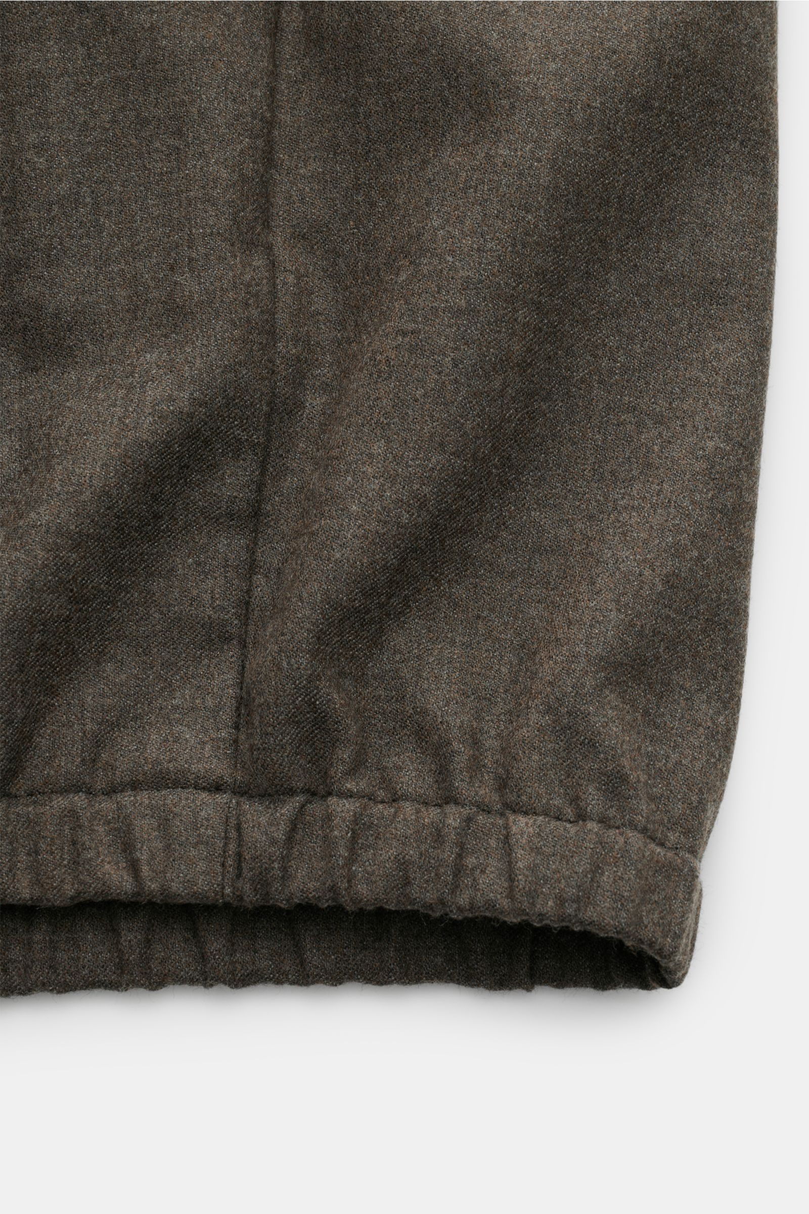 Close-up view of the elastic hem of The Product is the Hero Blouson 'Billy' grey-brown mottled, made of soft, crease-resistant wool blend.