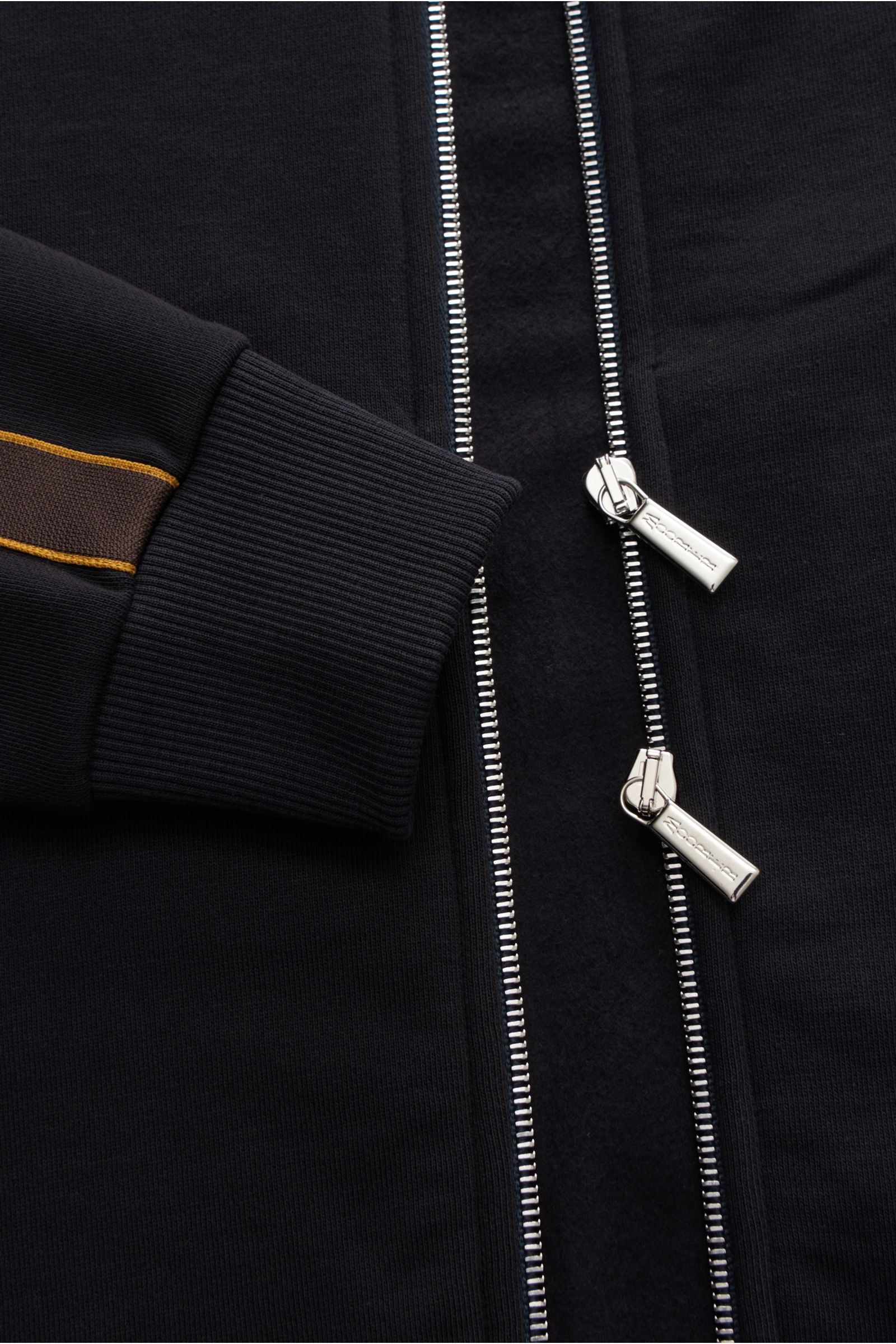 Close-up front view of Moorer Sweat jacket 'Jaiden' dark navy showing two-way zip, ribbed cuff with contrasting tuxedo stripes. Sweat made of pure cotton, soft feel, regular fit, raglan sleeves, high-closing standing collar, slanted hip pockets with snap 