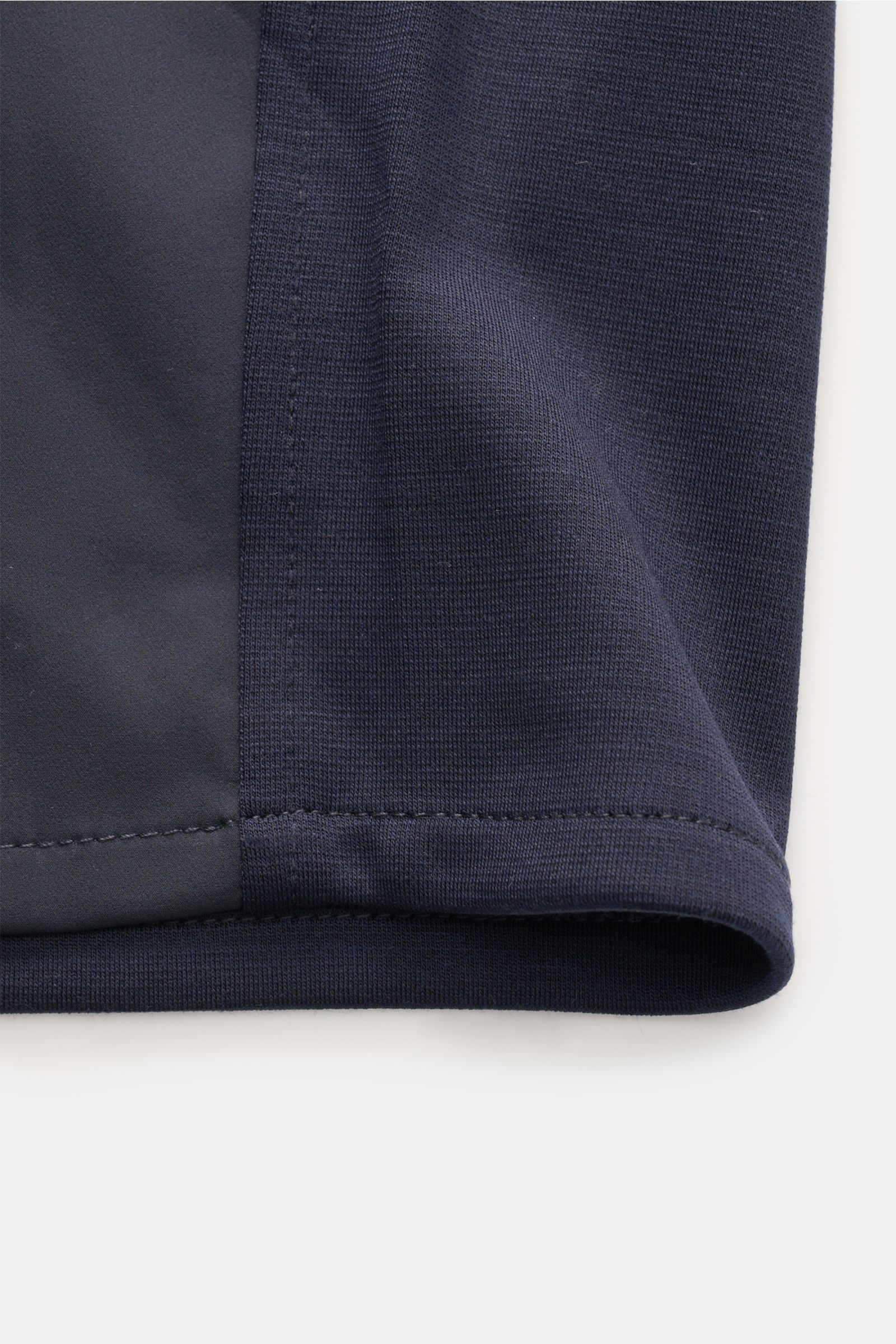 Close-up side view of the hem and fabric detail of the Marco Pescarolo Jacke 'Key' navy, showing the jersey sleeves and back panel with pure wool, elastic quality, regular fit, two-way zipper, stand collar, zipper pockets, button cuffs, and unlined design