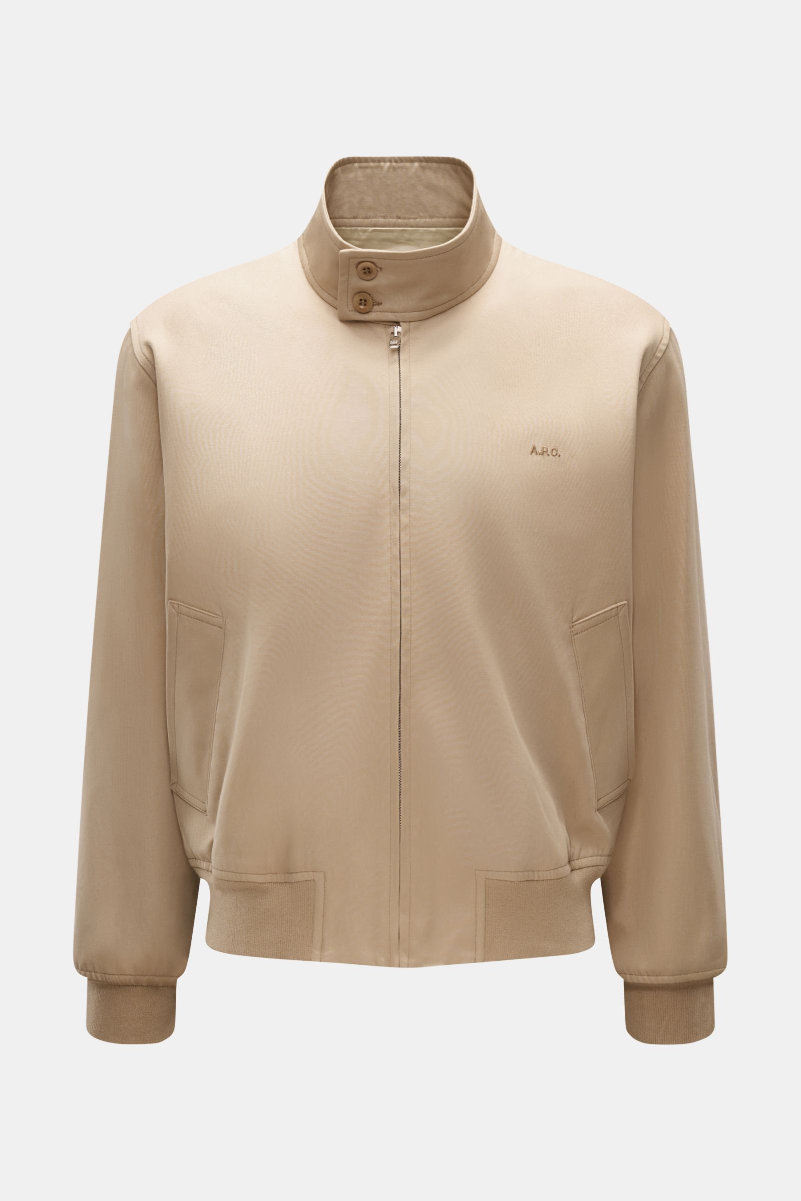 Front view of A.P.C. Blouson beige in pure cotton gabardine with buttoned standing collar, concealed zip, tonal logo stitching, slanted hip pockets, elastic hem and cuffs.

Description: Distinctive, urban and clean: This blouson by A.P.C. plays with cl