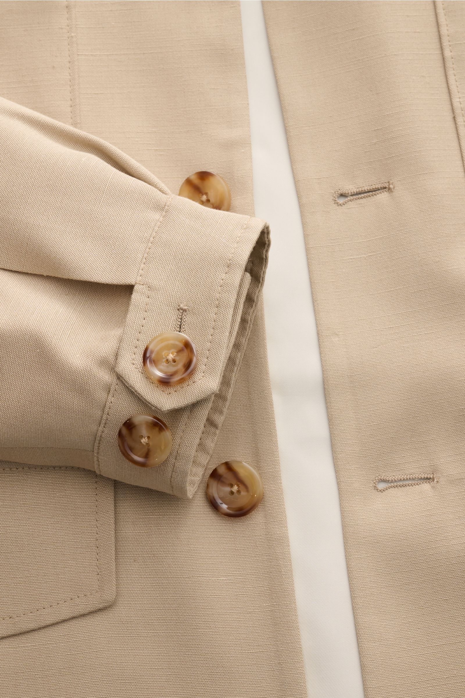 Close-up top view of Lardini Jacket 'Panosh' beige sleeve and button details, featuring viscose-silk fabric with smooth texture.