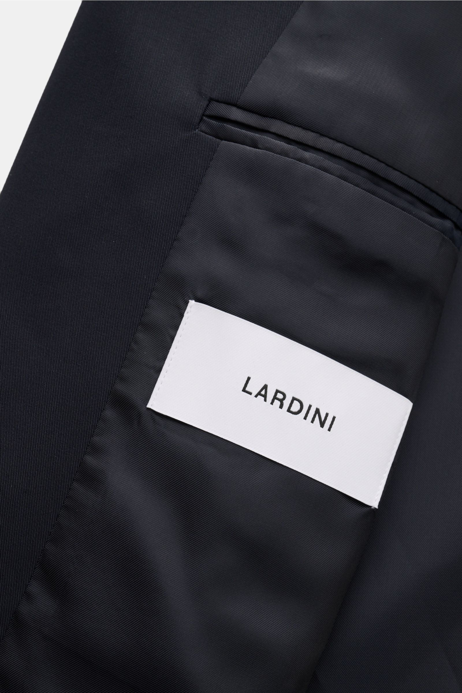 Close-up interior view of Lardini Jacke 'Pastone' navy showing the smooth lining, inner pocket with white LARDINI label, made of pure virgin wool.

The provided content in English for description:
A timeless companion for transitional seasons: The luxurio