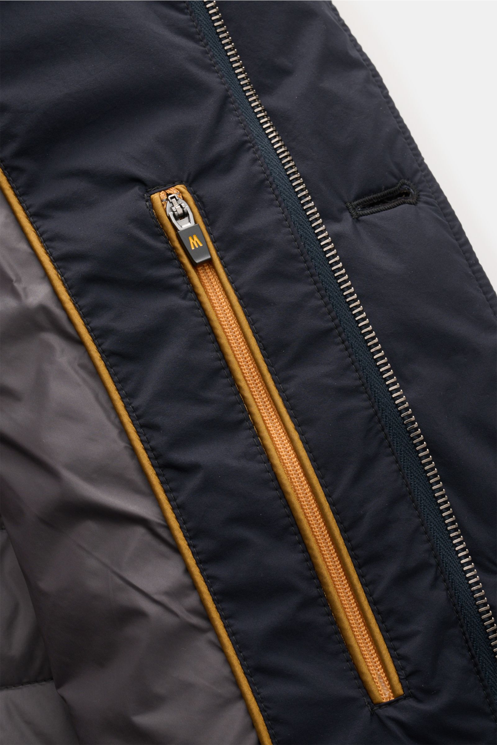 Close-up front view of Moorer Down jacket 'Zavyer' navy showing high-quality microfibre, smooth feel, slim fit, leather collar detail, two-way zip, storm flap with buttons, classic breast pocket, hip pockets with flap, smooth lining, and two inside pocket