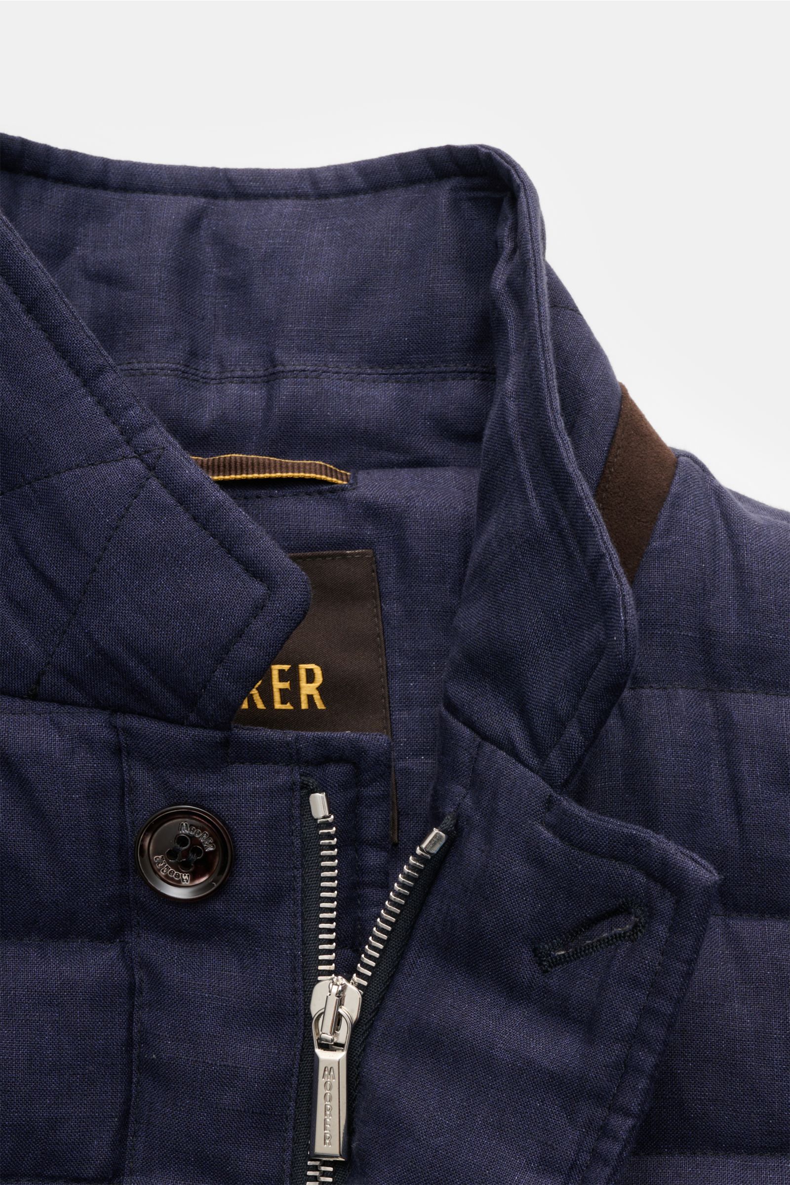 Close-up front view of the Moorer Down jacket 'Zavyer' navy mottled, showing the quilted pure linen fabric, leather collar detail, two-way zip, storm flap with button, and classic topstitch. The elegant quilted jacket 'Zavyer' by MOORER will see you throu