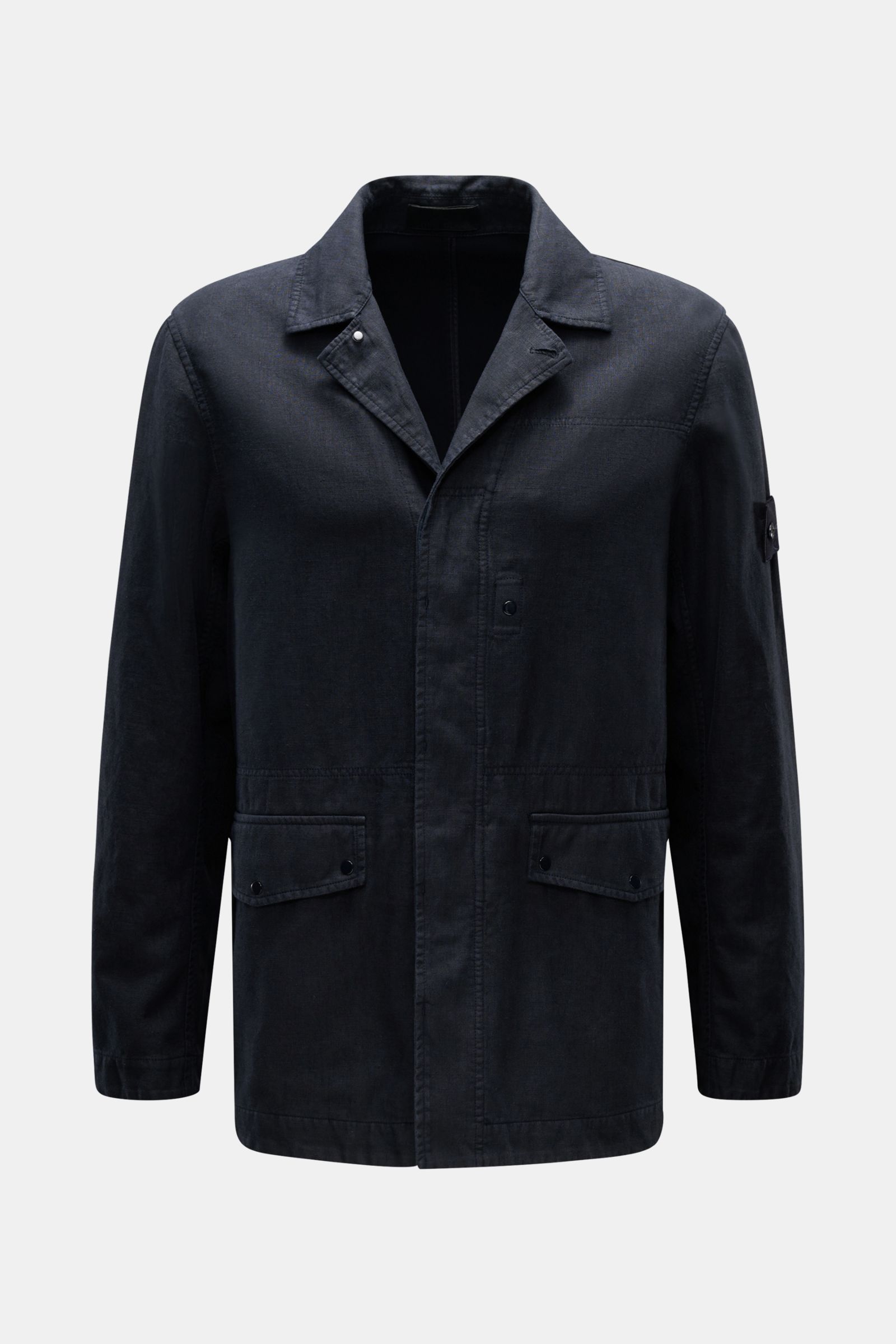Front view of Stone Island Jacket 'Ghost Piece' navy in linen and microfiber blend, slim fit with concealed button placket, adjustable collar, flap hip pockets, tonal sleeve badge, and snap button cuffs, perfect for spring casual wear.