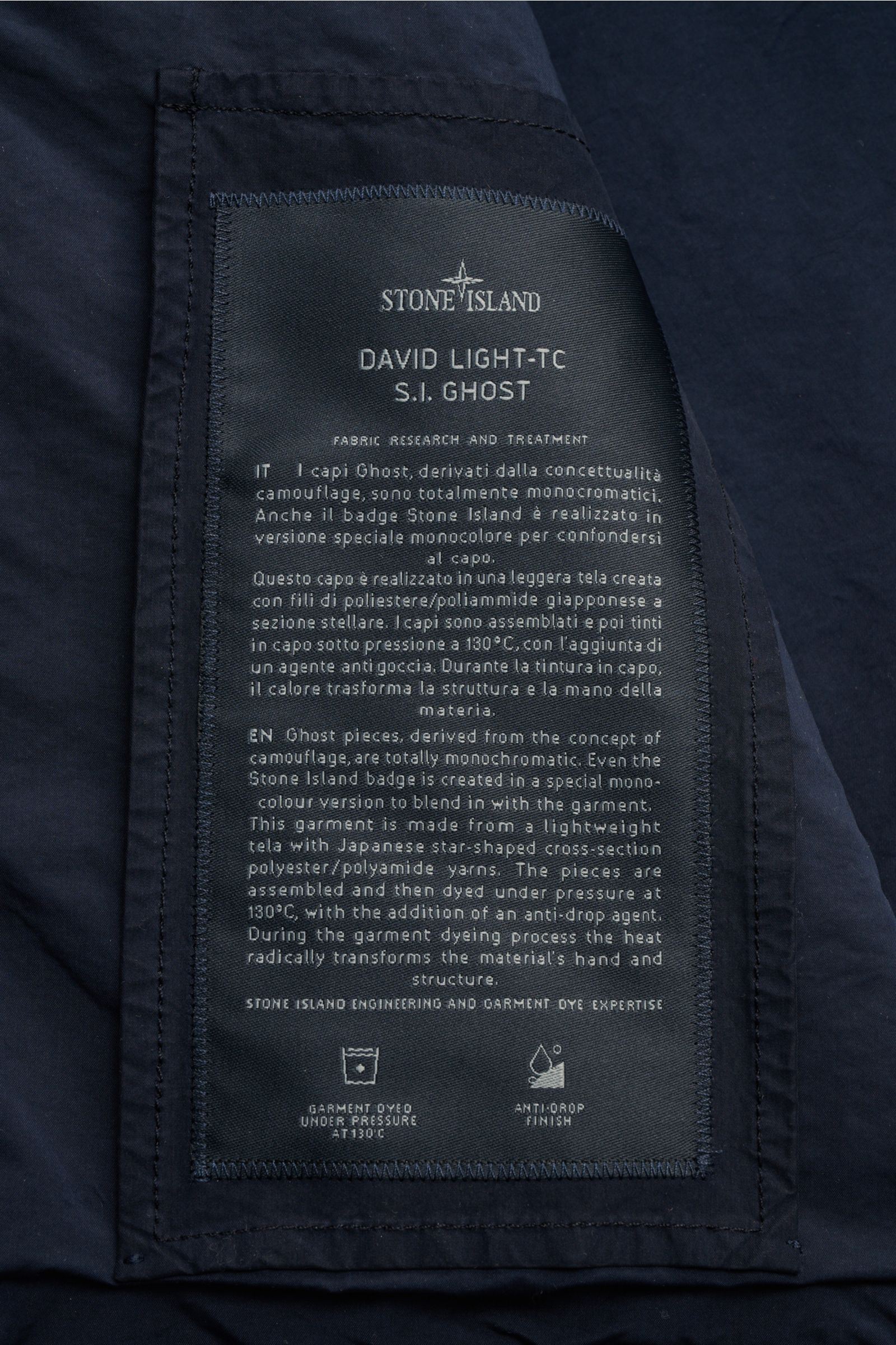 Stone Island Jacke 'Ghost Piece' navy close-up of inner label showing fabric research details, photographed from inside front side. Urban essential: high-quality microfiber, soft touch, slim fit, snap button placket, turn-down collar with button tab, fron