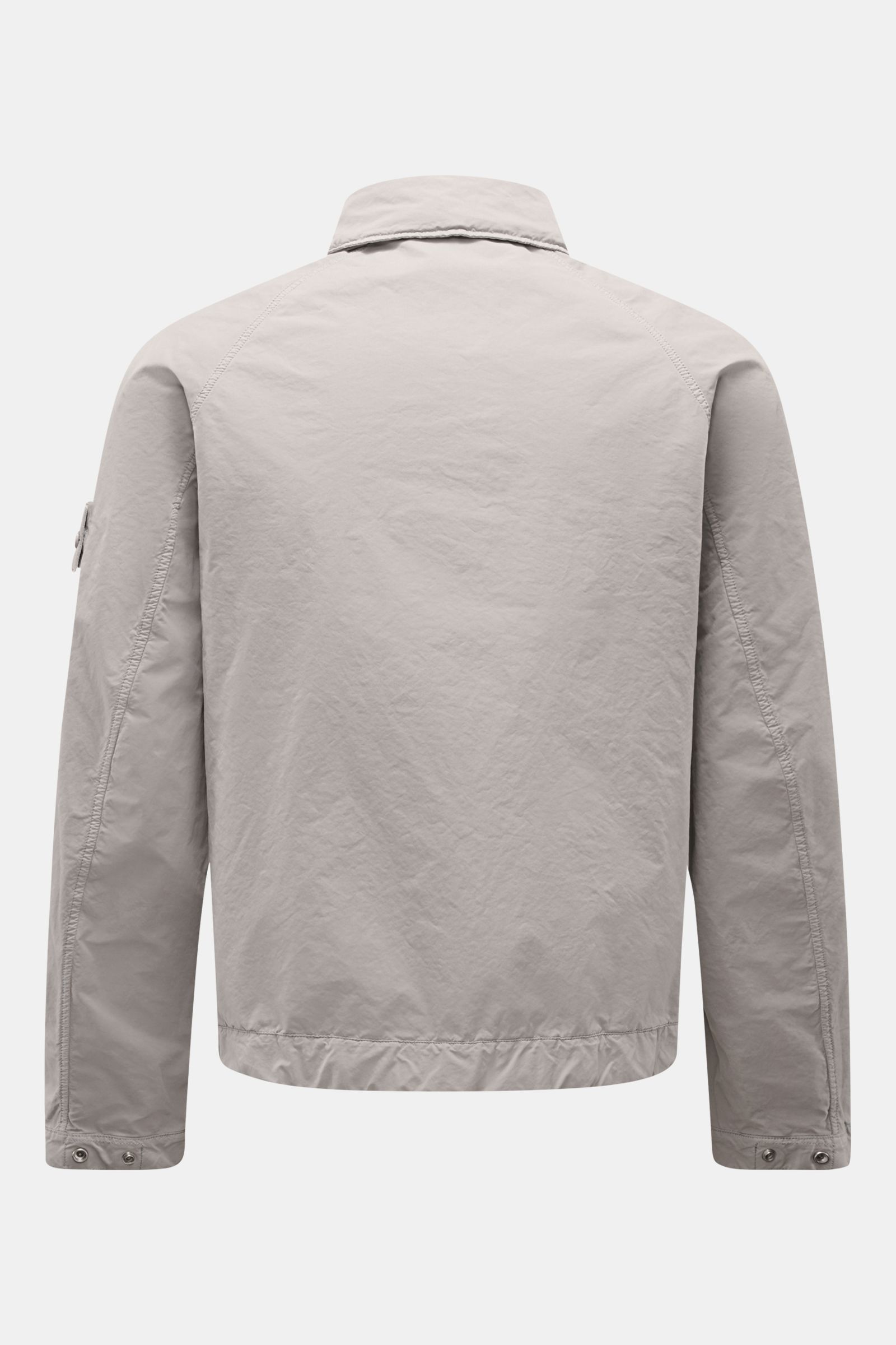 Stone Island Jacket 'Ghost Piece' light grey shown from the back, featuring high-quality microfibre, soft feel, slim fit, snap button placket, turn-down collar with buttoned tab, front flap pockets, tonal compass badge on upper sleeve, and snap button cuf