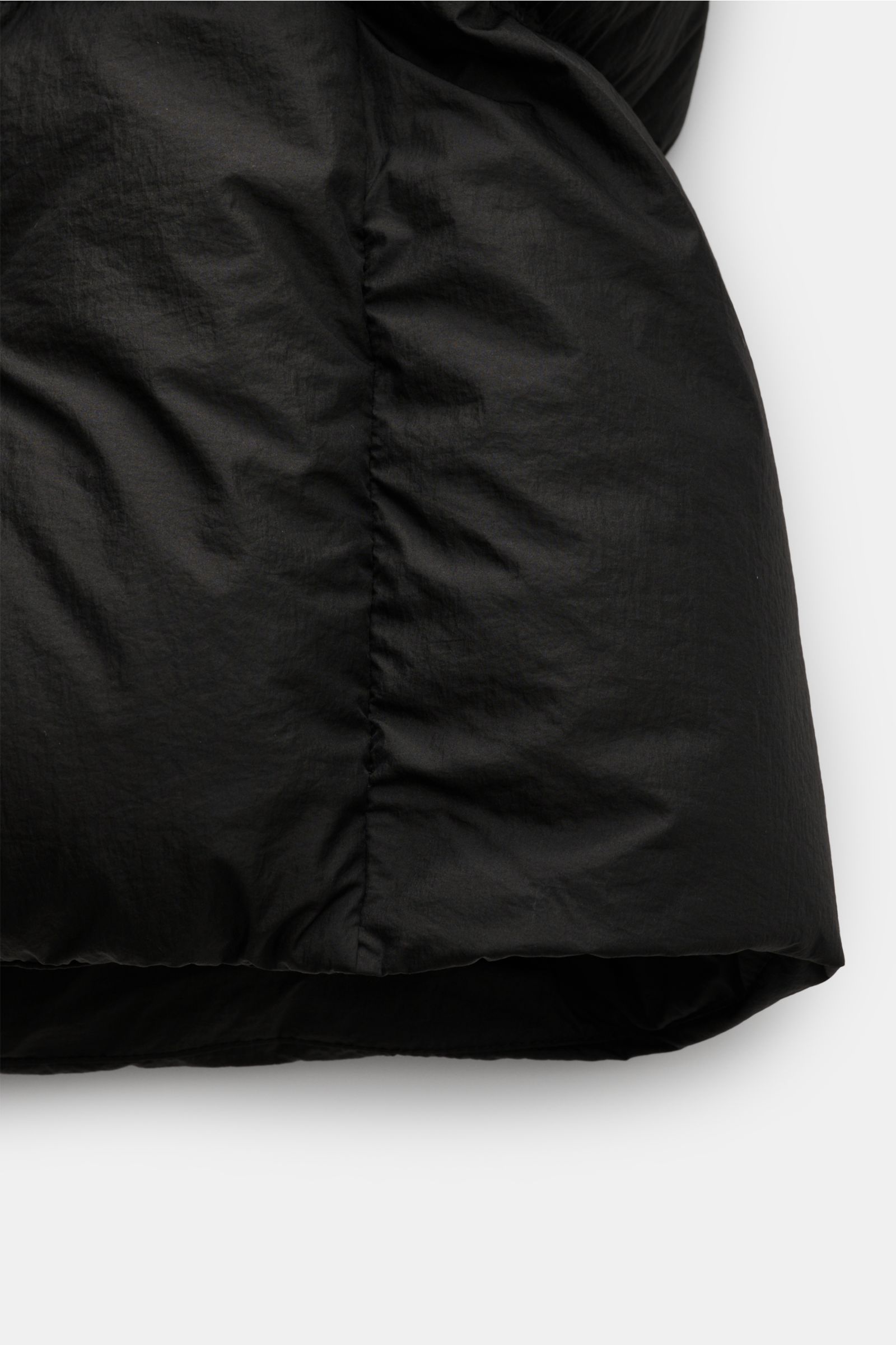 Close-up side view of the black Stone Island Down jacket 'Seam Faded Light Nylon Tela' showing smooth microfibre fabric and stitching details.

Stay in style even on cold days: This down jacket by STONE ISLAND has a warm down lining that makes it a ver