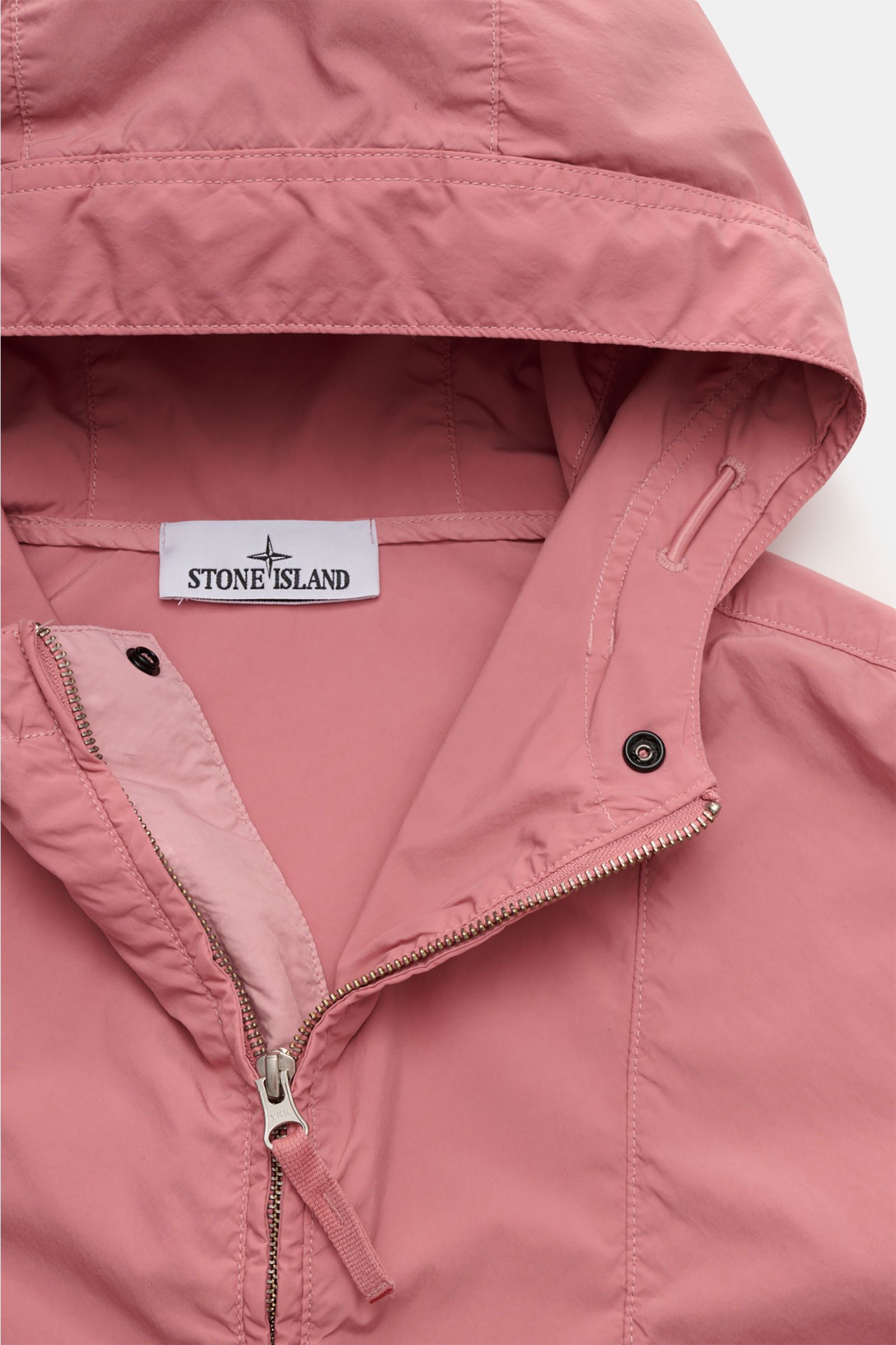 Stone Island Jacket 'Light Compact Touch Poly-TC' antique pink shown from a close-up top-front perspective, highlighting the hood, zipper, and stitching details. Made for changeable days: The lightweight, water repellent jacket 'Light Compact Touch Pol