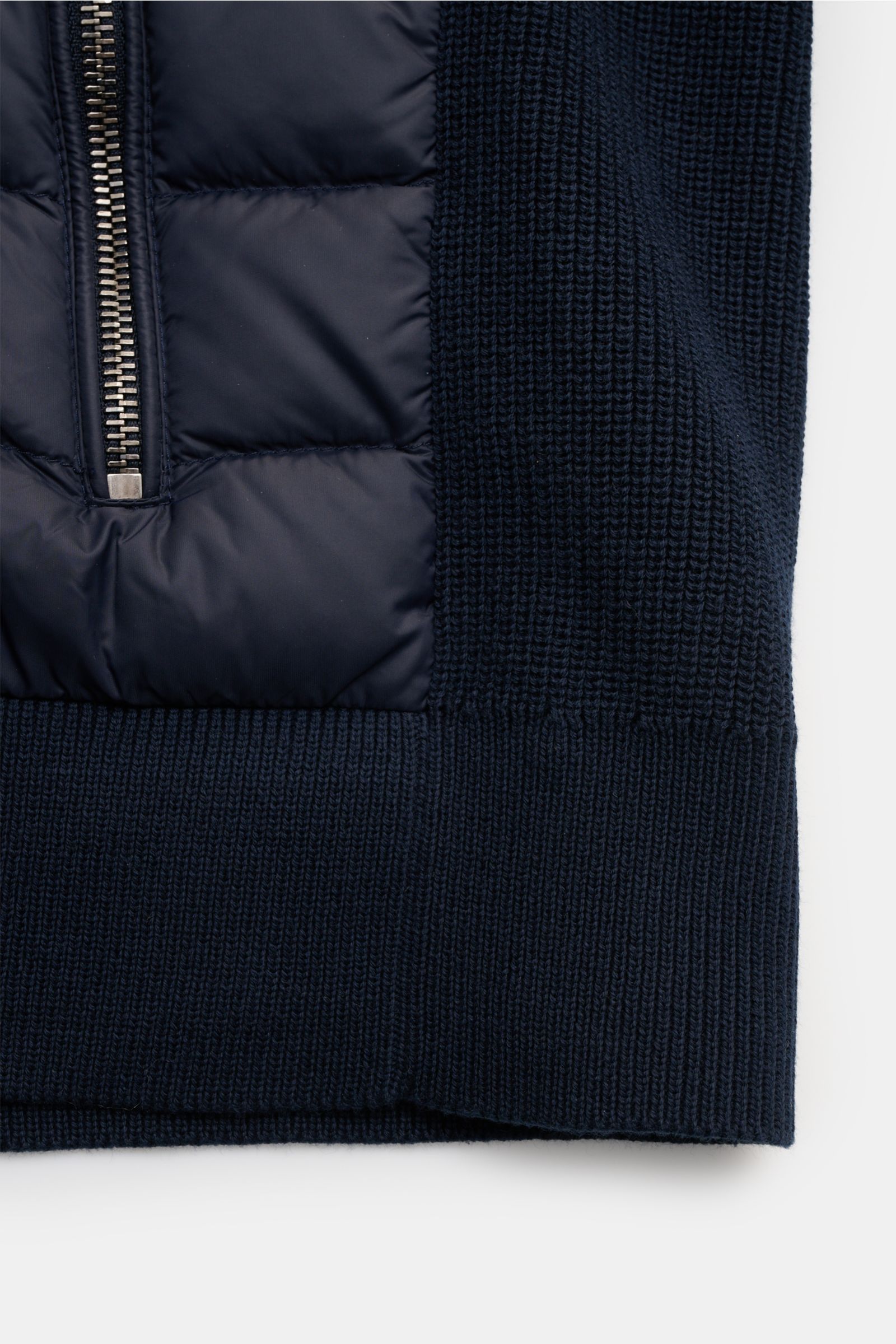 Close-up front view of the Belstaff Daunenjacke 'Control Cardigan' navy showing the quilted microfiber front with down filling, extra slim fit, two-way zipper, ribbed wool knit sleeves and hem, high stand collar, and the BELSTAFF web label on the upper ar