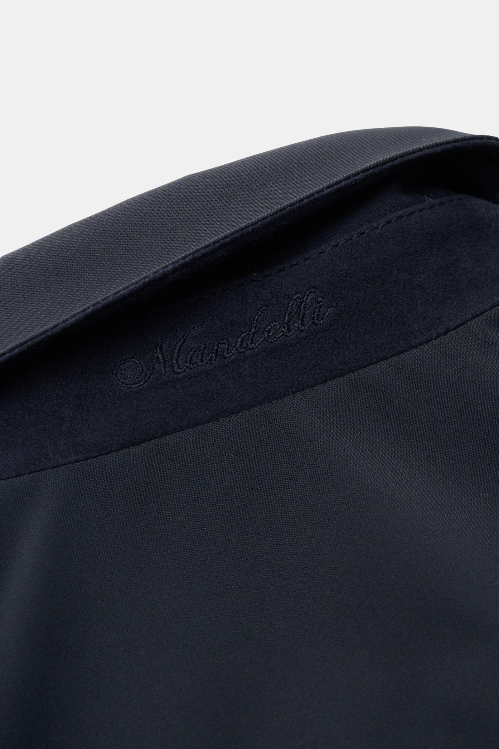Mandelli Blouson navy close-up from above showing the collar with subtle quilting, smooth microfiber, and embroidered logo.