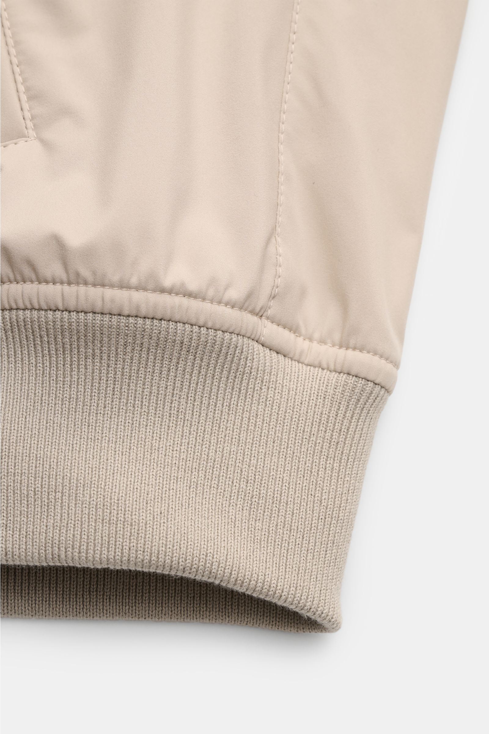 Close-up view of the ribbed cuff of the Mandelli Blouson beige, showcasing high-quality microfibre, soft feel, and goat suede trim. A perfect symbiosis of luxury and comfort: This blouson by MANDELLI is confidently elegant and effortlessly enhances your o