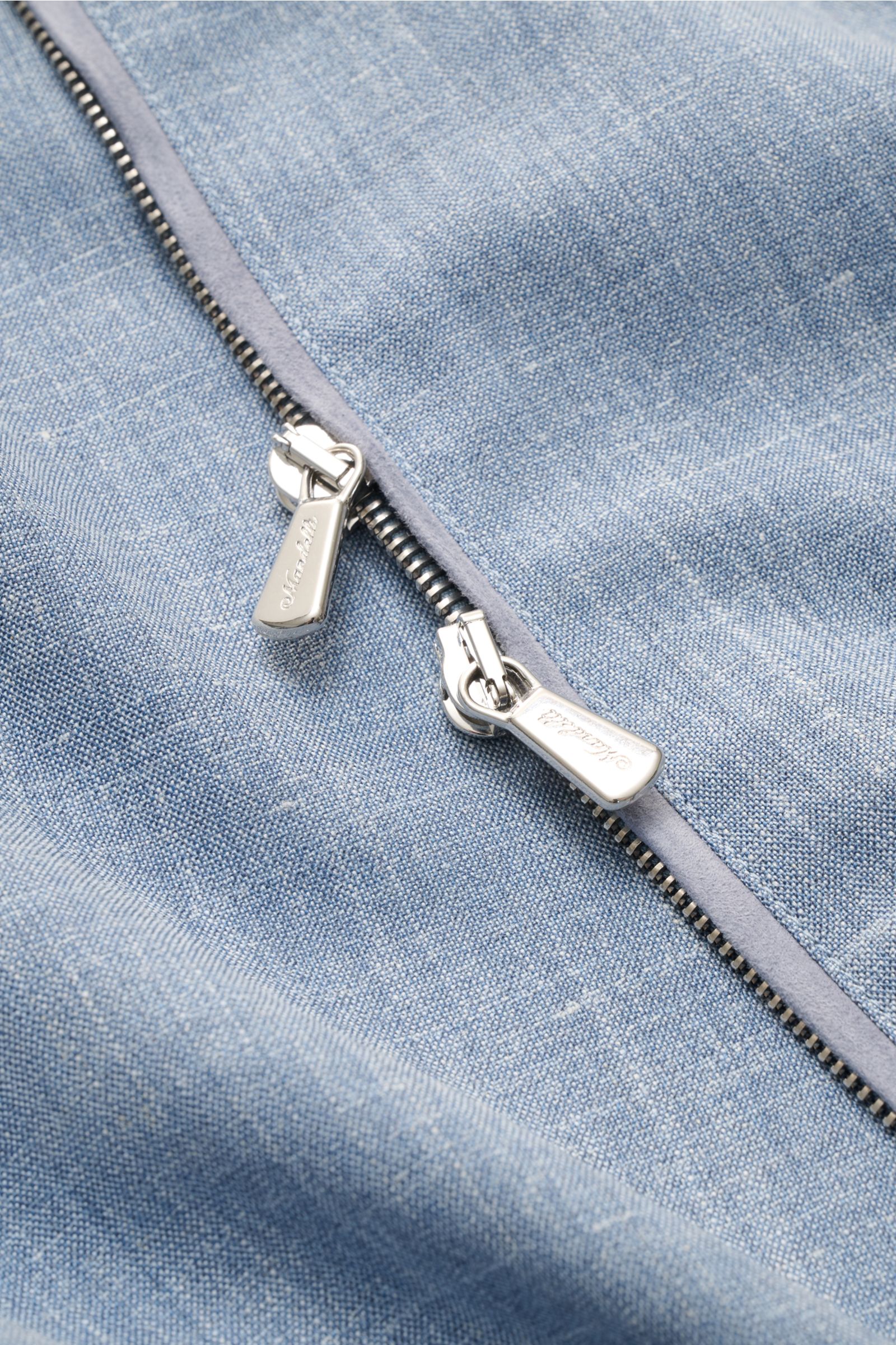 Close-up front view of the Mandelli Blouson smoky blue mottled, showcasing its two-way silver zipper on soft virgin wool, silk, and linen blend fabric. Confident ease for the transitional period: Its luxurious character makes this blouson by MANDELLI an e