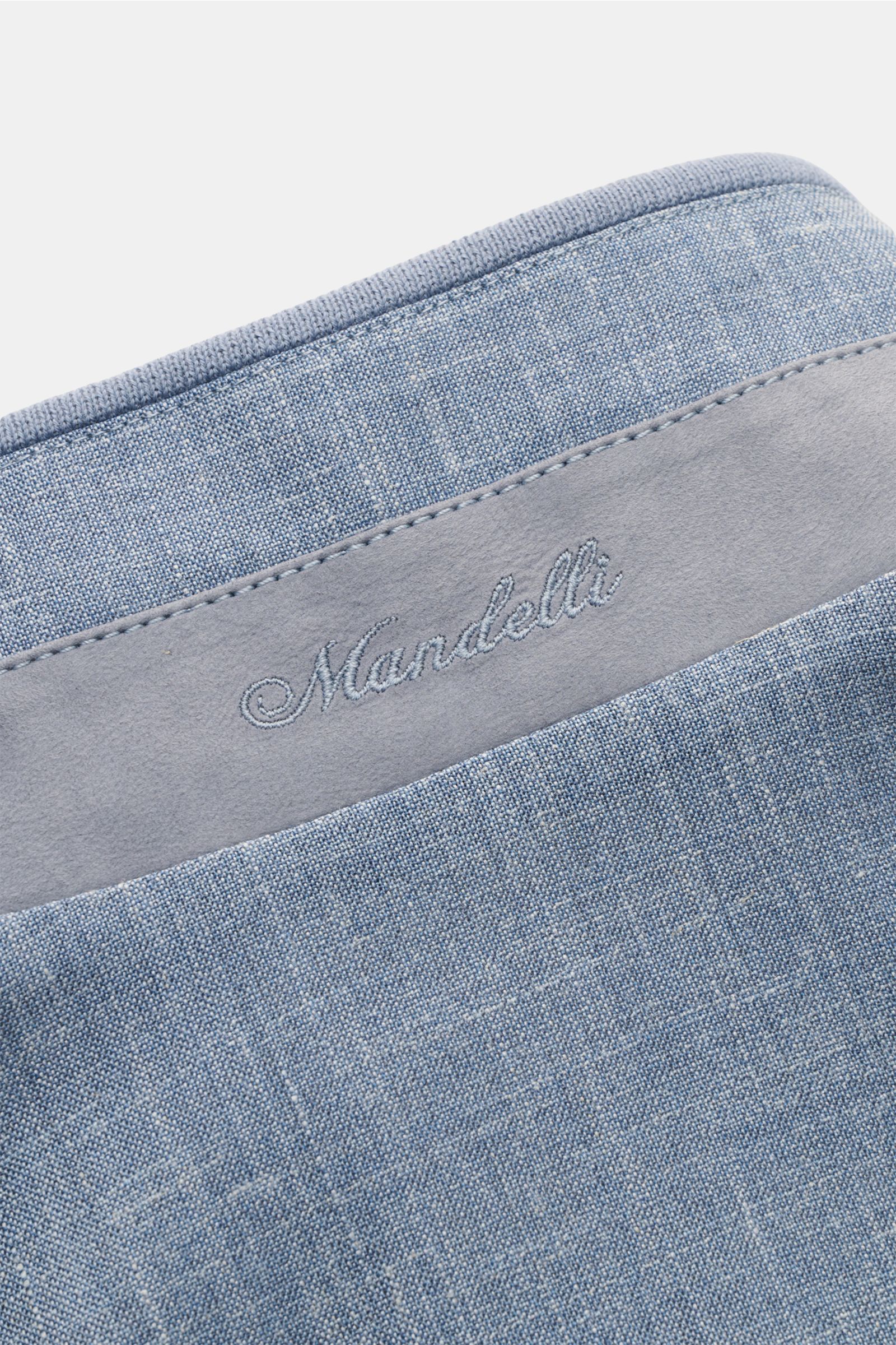 Close-up top view of Mandelli Blouson smoky blue mottled showing soft virgin wool, silk, linen blend with embroidered logo on standing collar.