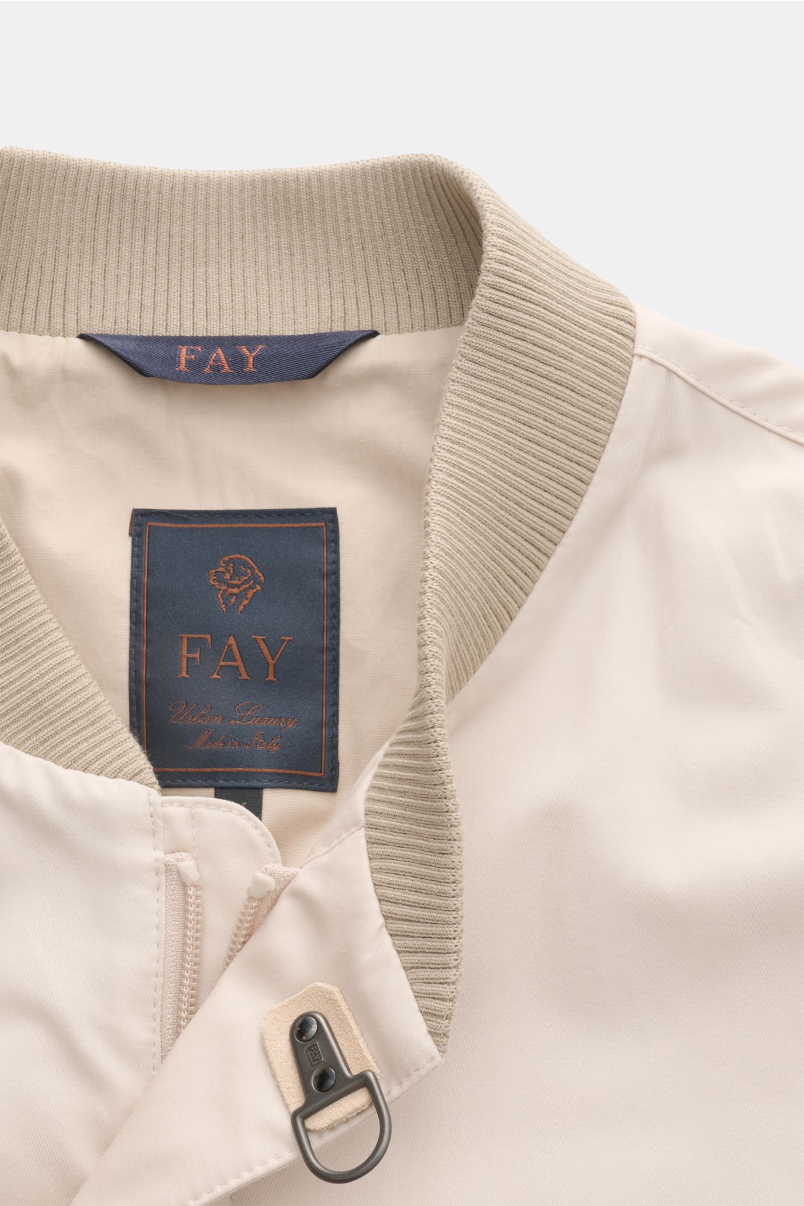 Fay Blouson beige close-up from above showing rib knit collar, two-way zip, storm flap with snap buttons, and signature carabiner closure. A luxurious all-rounder for the transitional period: This blouson by FAY effortlessly enhances sophisticated leisure