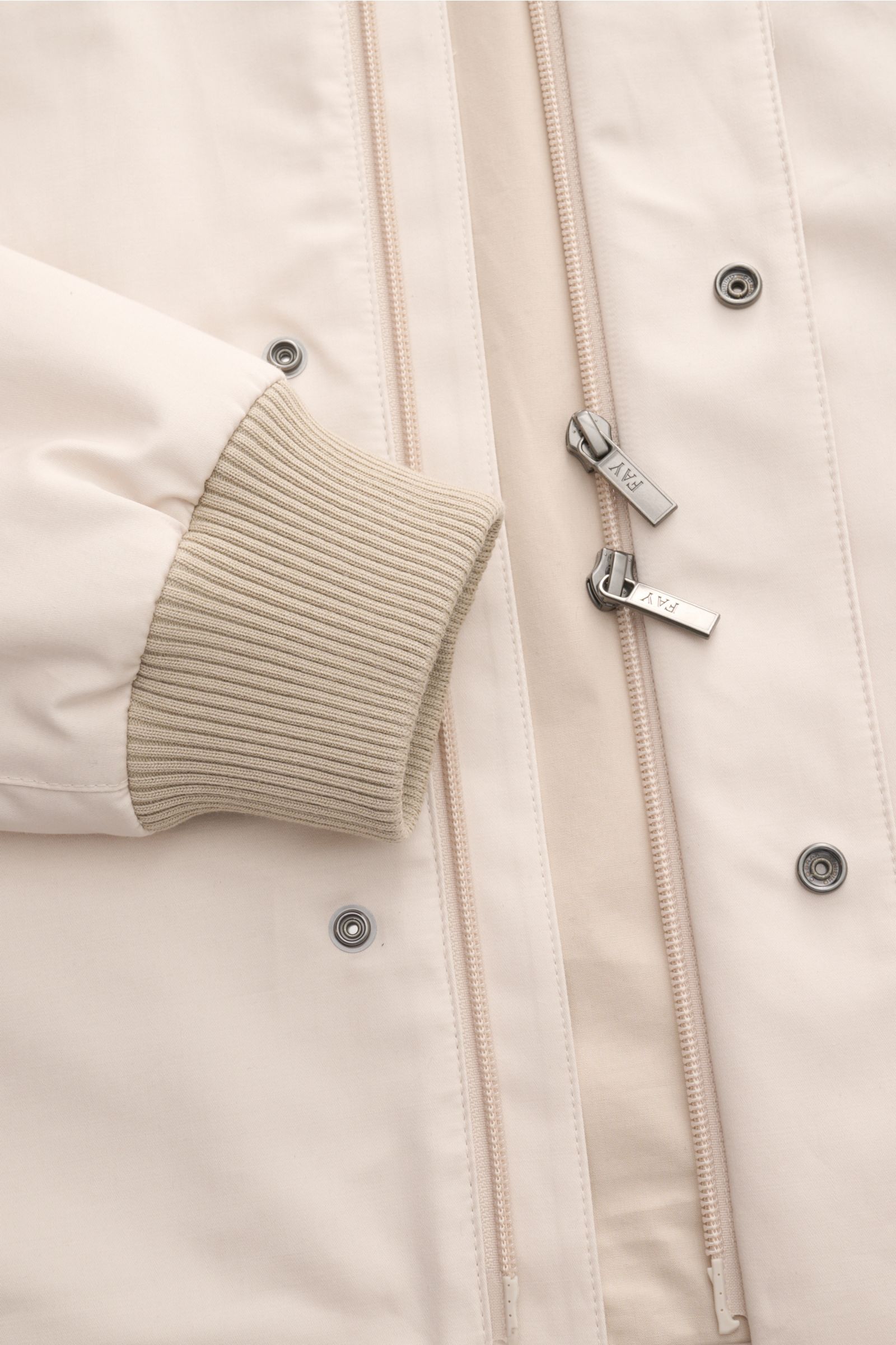 Close-up front view of the Fay Blouson beige showing rib knit elasticated cuff, two-way zip with signature carabiner closure, storm flap with snap buttons, and smooth cotton, silk, and cashmere blend fabric. A luxurious all-rounder for the transitional pe