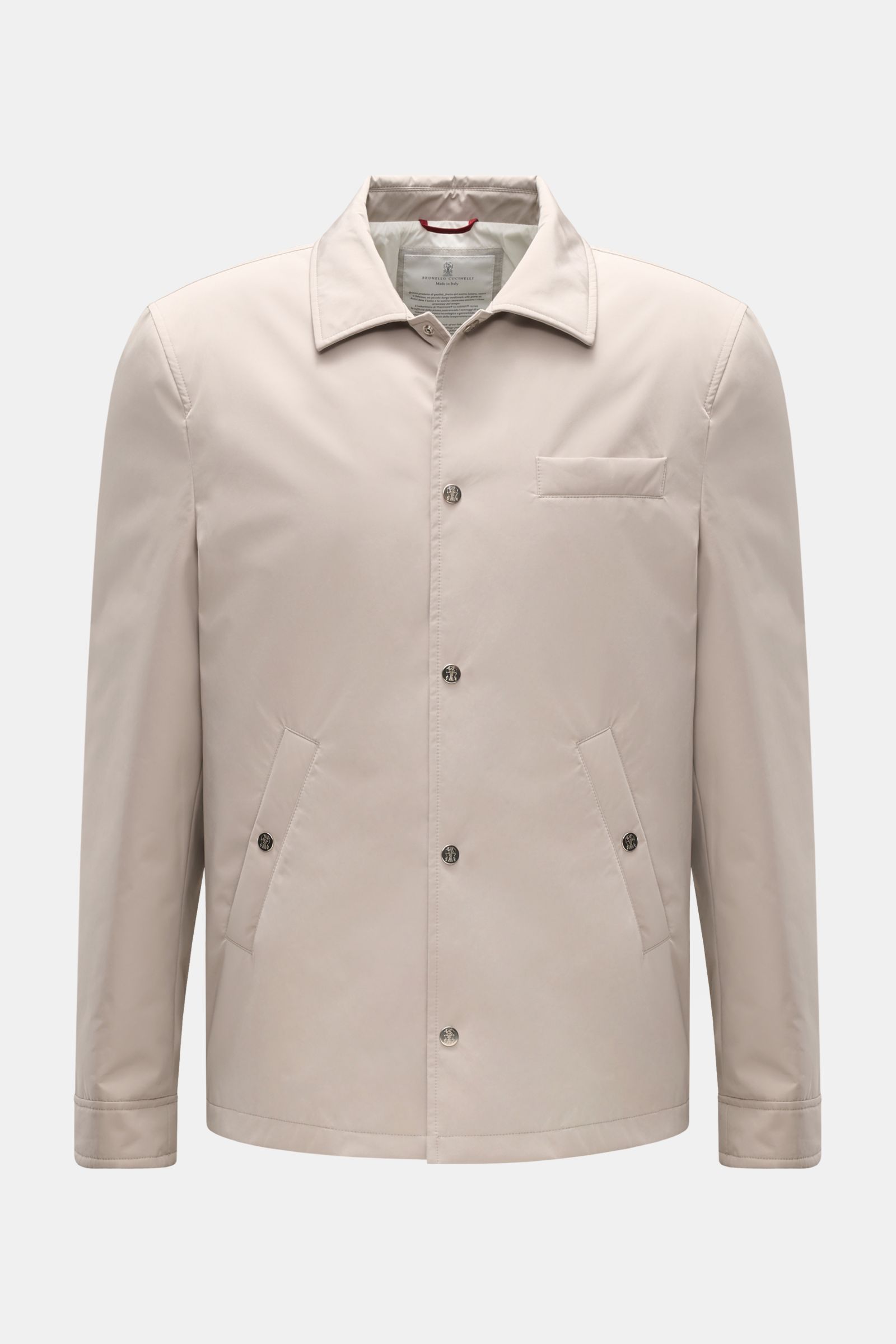 Front view of the Brunello Cucinelli Jacke sand, a sand-colored jacket made of high-quality microfiber with a soft, smooth touch, featuring a regular fit, snap-button placket, turn-down collar, classic chest pocket, angled hip pockets with snap buttons, s
