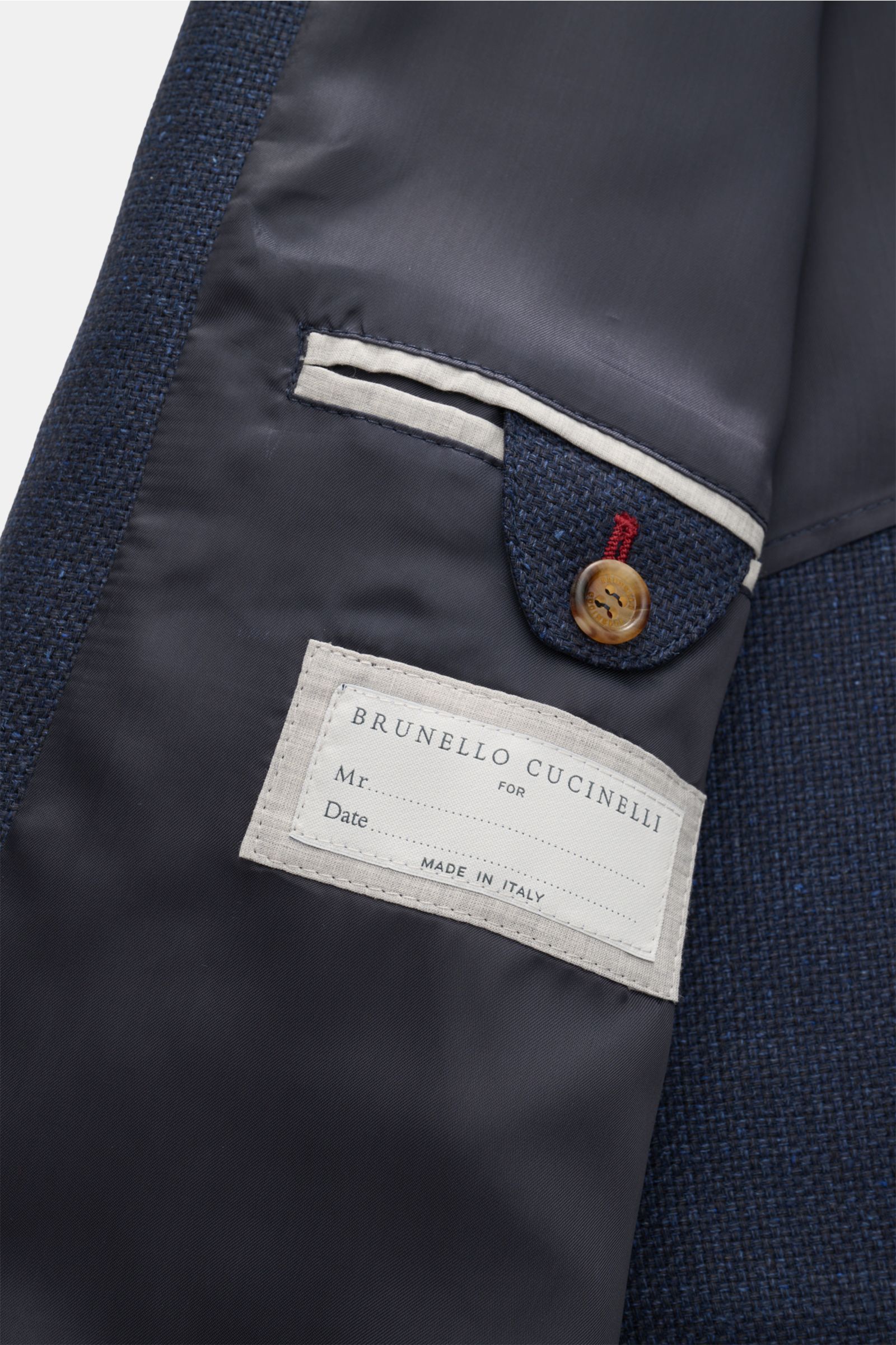 Close-up inside view of the Brunello Cucinelli Blouson navy mottled showing the label, buttoned inside pocket flap, and smooth lining.

Description (not part of alt tag but for reference):
Lightweight and elegant, with an unmistakable presence: This blous