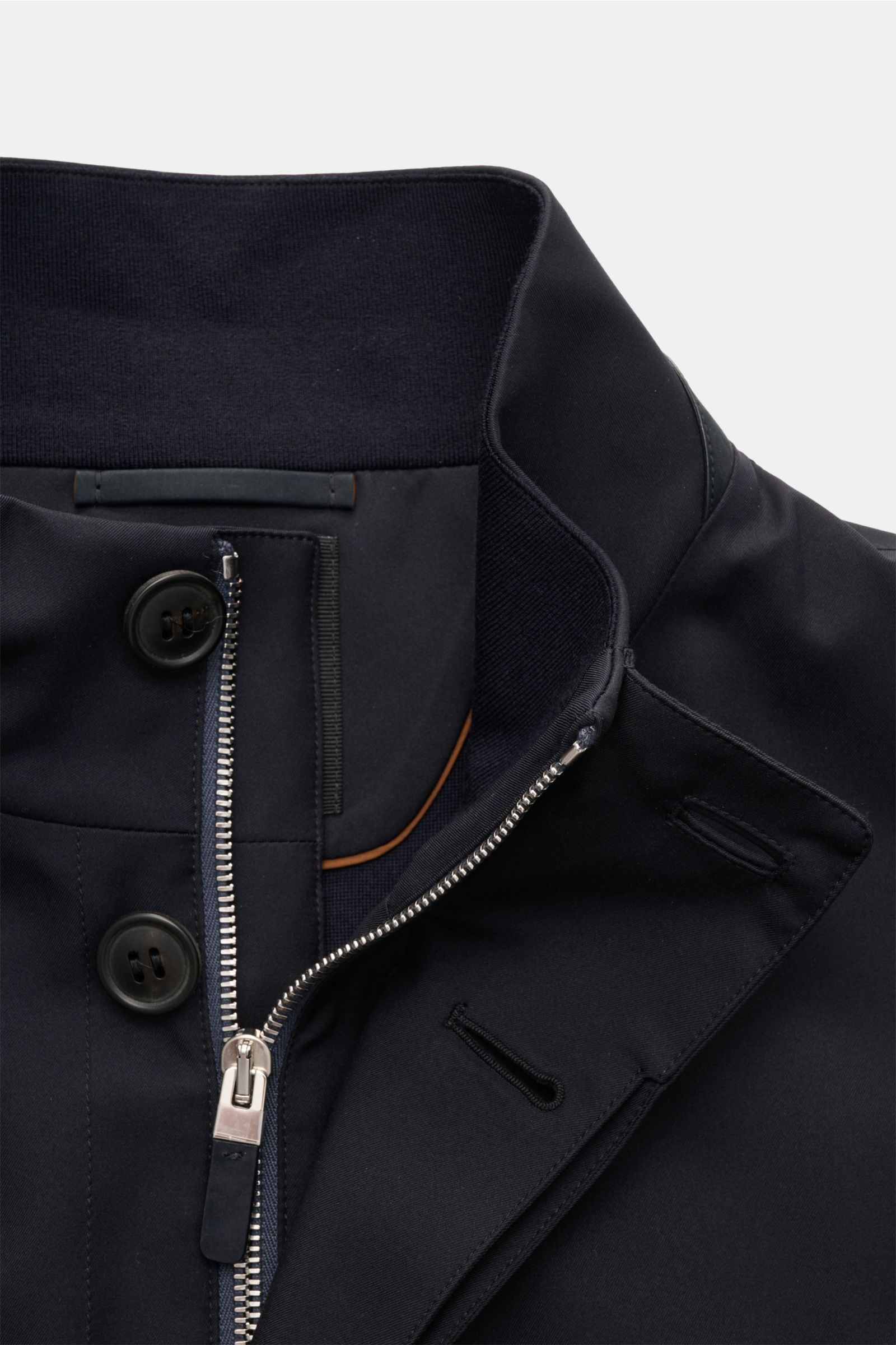Close-up front view of Zegna Jacket 'Motorin' navy showing button and zipper closure, standing collar with leather trim, and fine stitching. 