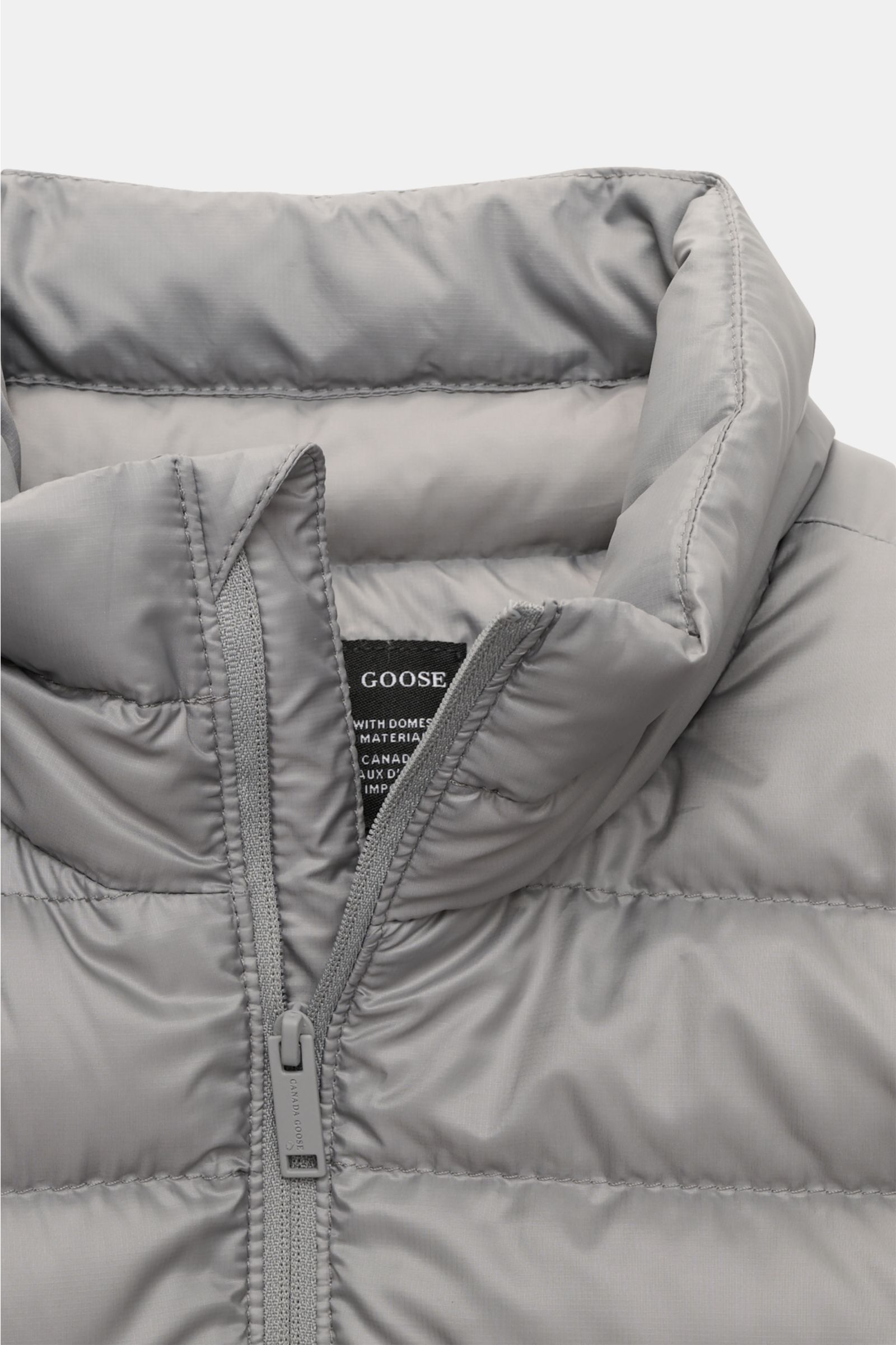 Canada Goose Down jacket 'Stratus Tonal' light grey shown from a close-up front perspective highlighting the padded standing collar and zip. The super lightweight 'Stratus Tonal' down jacket by CANADA GOOSE with high-quality ripstop outer material is s