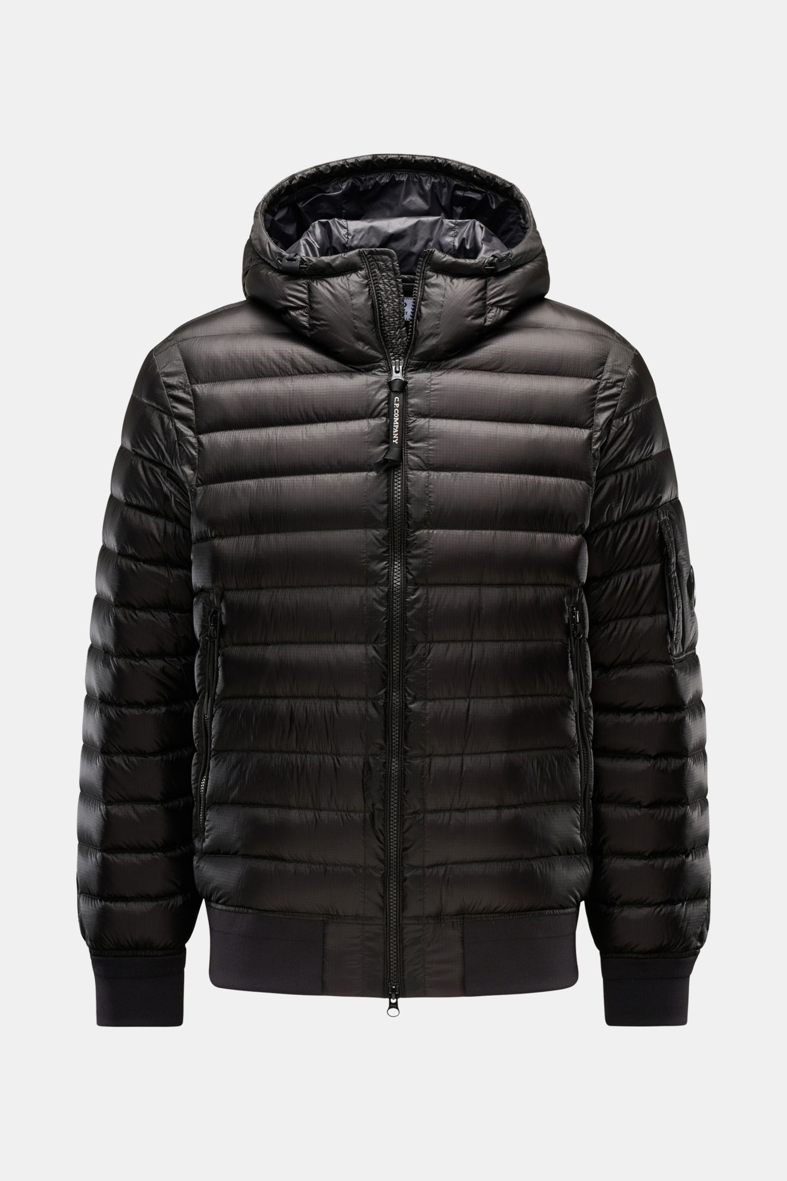 Front view of C.P. Company Down bomber jacket black with water repellent ripstop surface, lightweight down padding, slim fit, and drawstring hood. Technical lightness in its most modern form: This blouson by C.P. COMPANY has a water repellent ripstop surf
