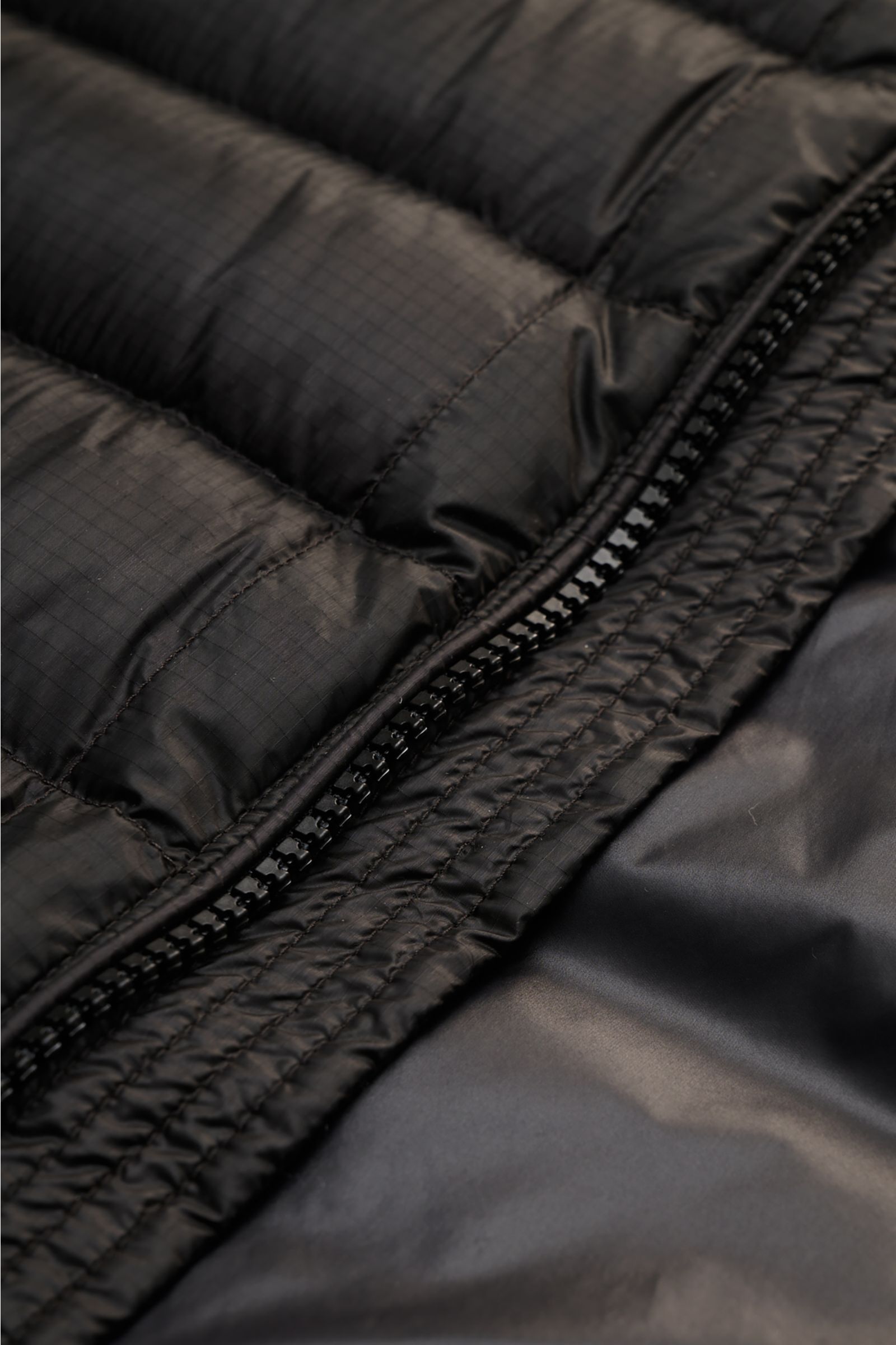 Alt tag (125 characters max): Close-up front view of C.P. Company Down bomber jacket black showing ripstop fabric, zipper, and smooth lining detail.

Expanded description: 
Technical lightness in its most modern form: This blouson by C.P. COMPANY has a wa