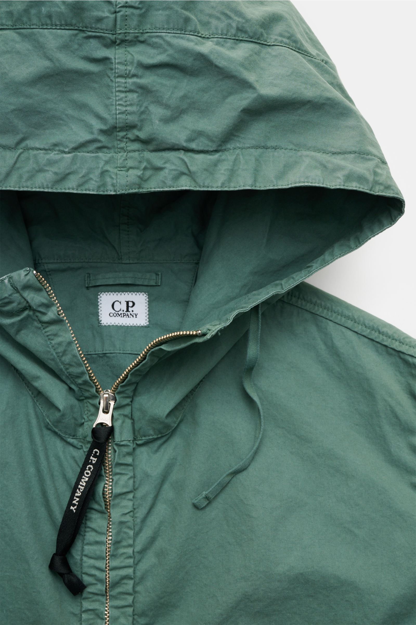 Close-up front view of the C.P. Company Jacket sage hood and zipper, made of pure cotton Micro-Reps fabric with a soft, garment-dyed look.