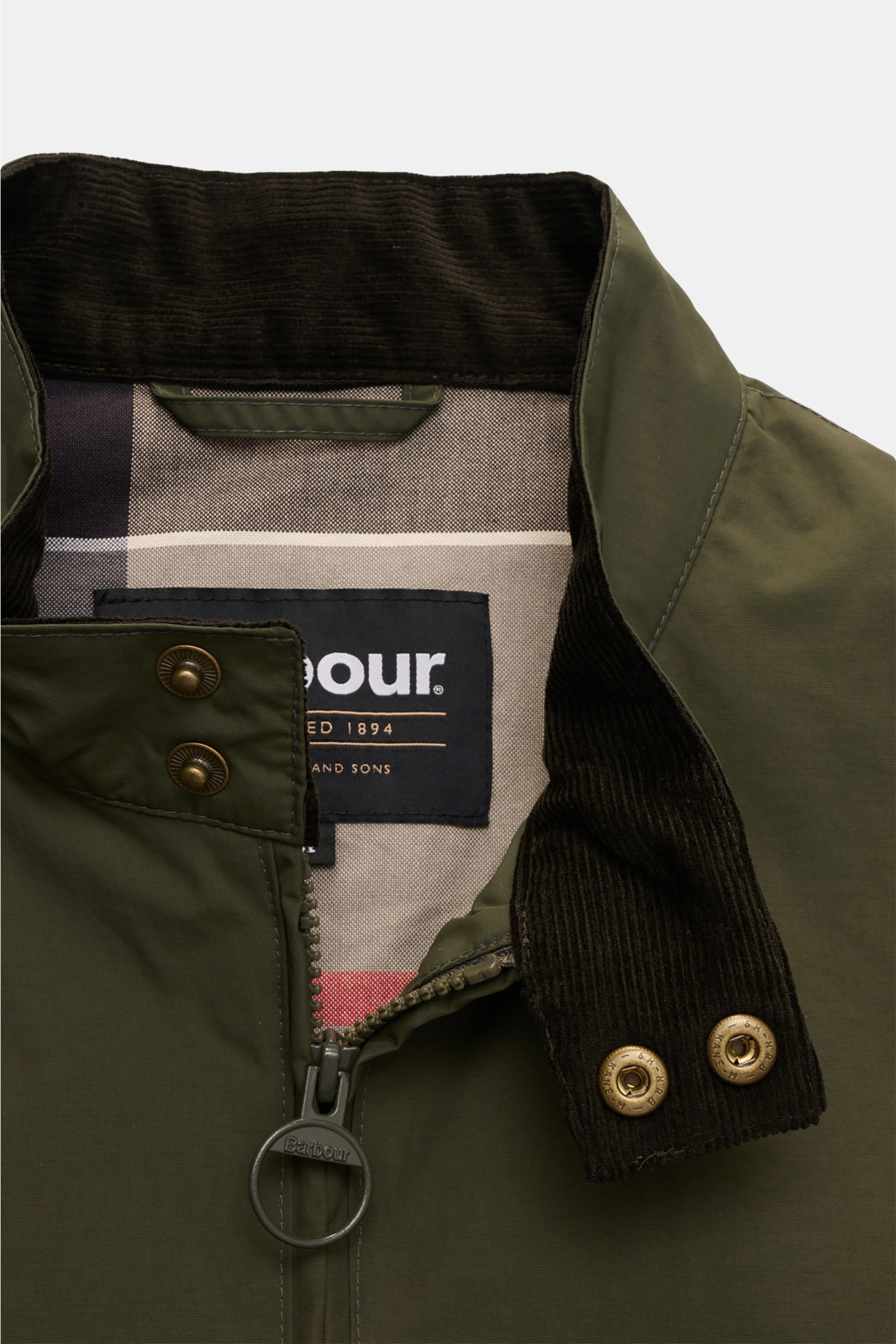 Close-up front view of Barbour Blouson 'Royston' olive jacket showing standing collar with corduroy trim, two snap buttons, and branded two-way zip.

Description: Modern blouson by traditional label BARBOUR: With its short cut and signature corduroy tr