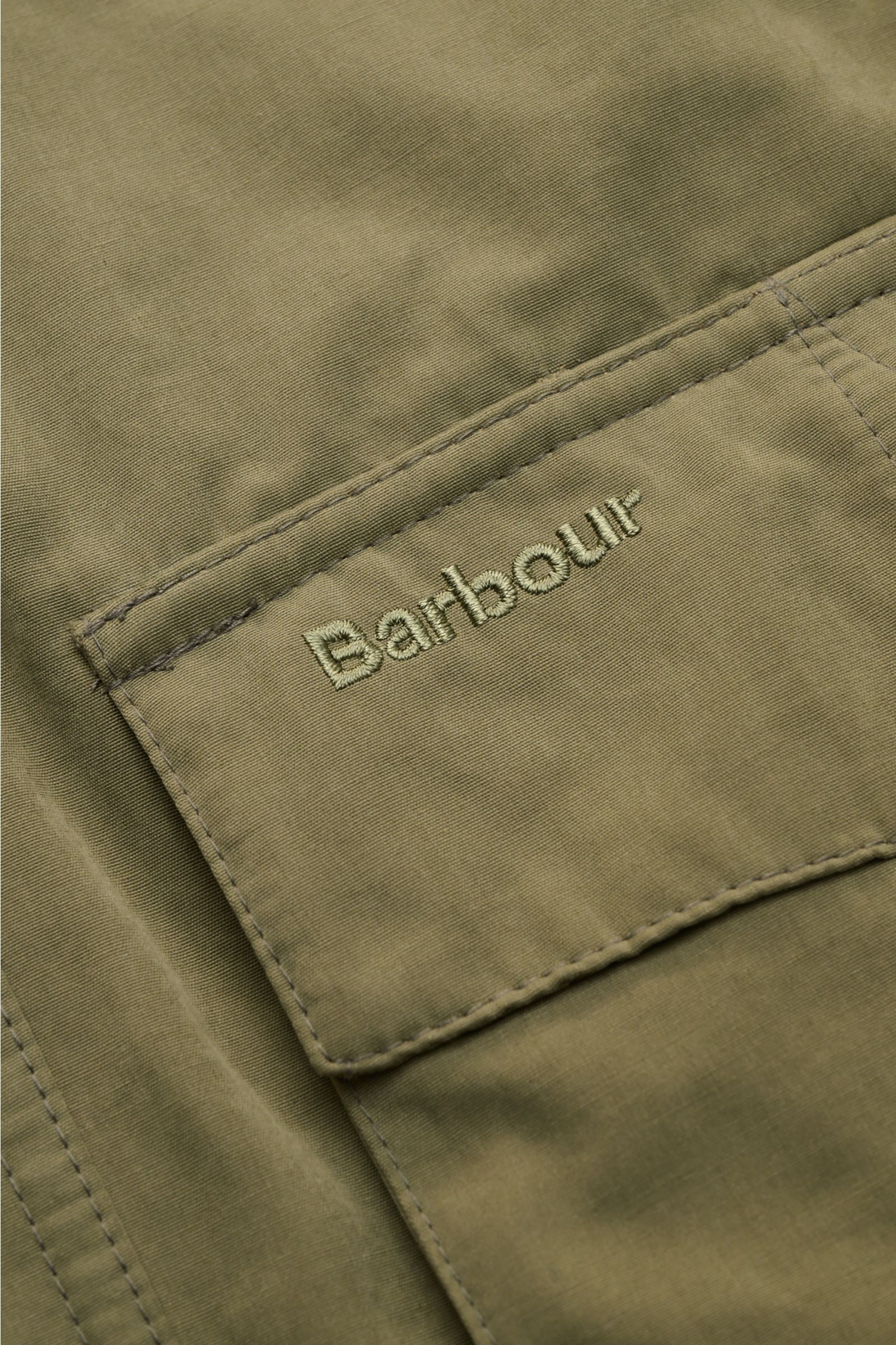 Close-up front view of the Barbour Field jacket 'Sanderling' olive showing embroidered logo on a pocket of lightweight cotton and microfiber fabric.