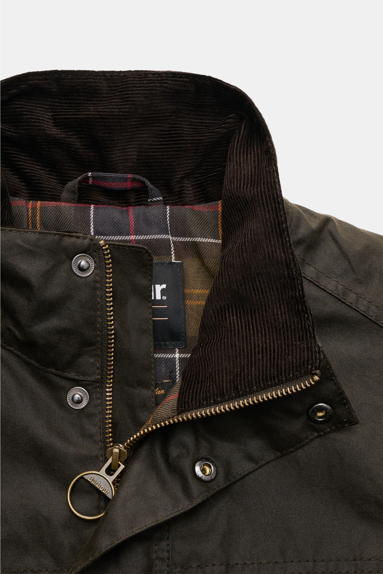 Close-up front view of Barbour Waxed jacket 'Sander' dark olive showing waxed cotton, corduroy collar, checked lining, two-way zip, and snap buttons.

Protection against wind and weather in classic BARBOUR style: The waxed surface of the pure cotton ja