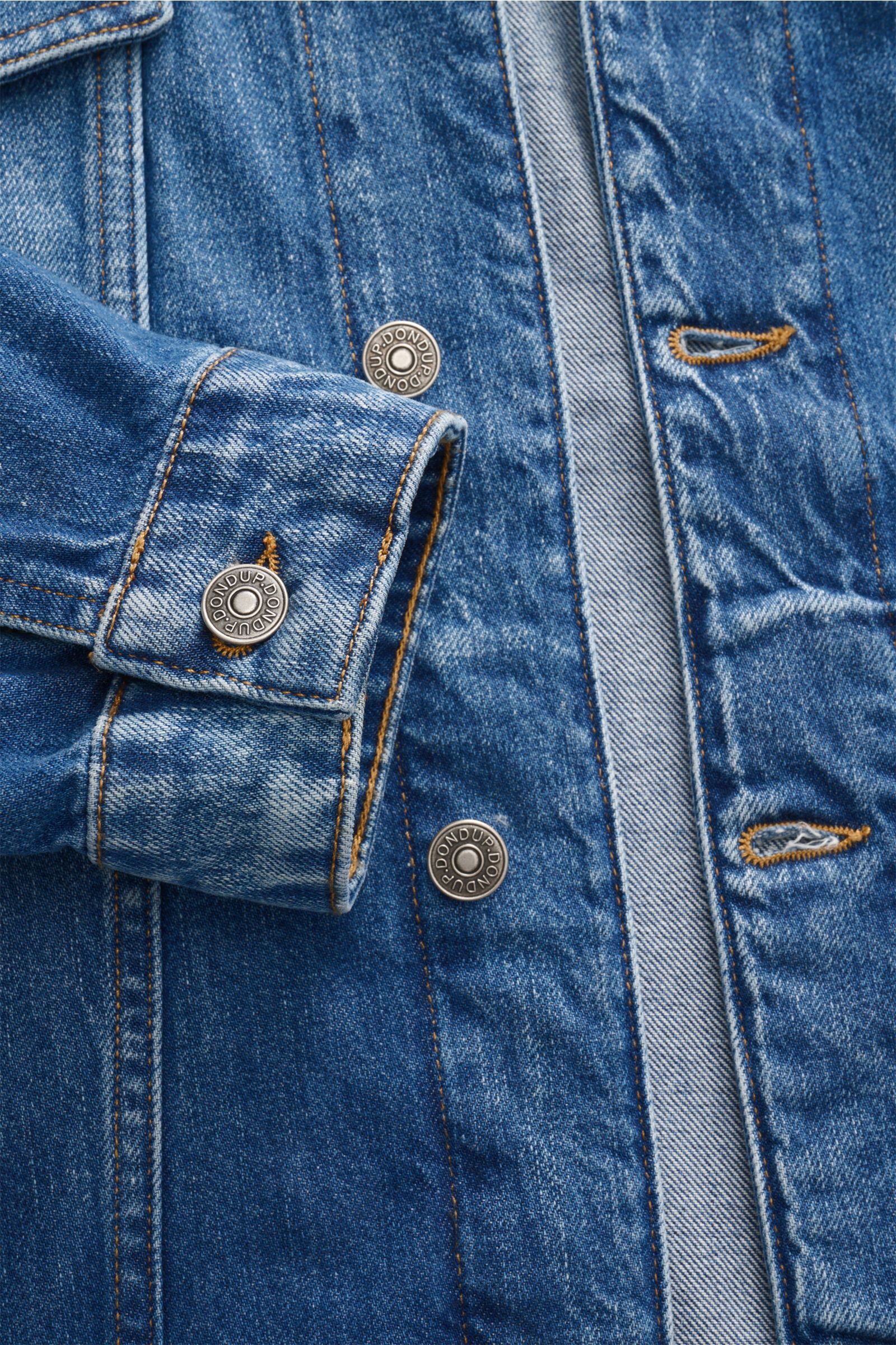 Close-up front view of Dondup Denim jacket blue showing slim fit, contrasting seams, six-button placket, turn-down collar, and buttoned cuffs.

Timeless denim essential: The DONDUP denim jacket is perfect for stylish casual looks this spring.


