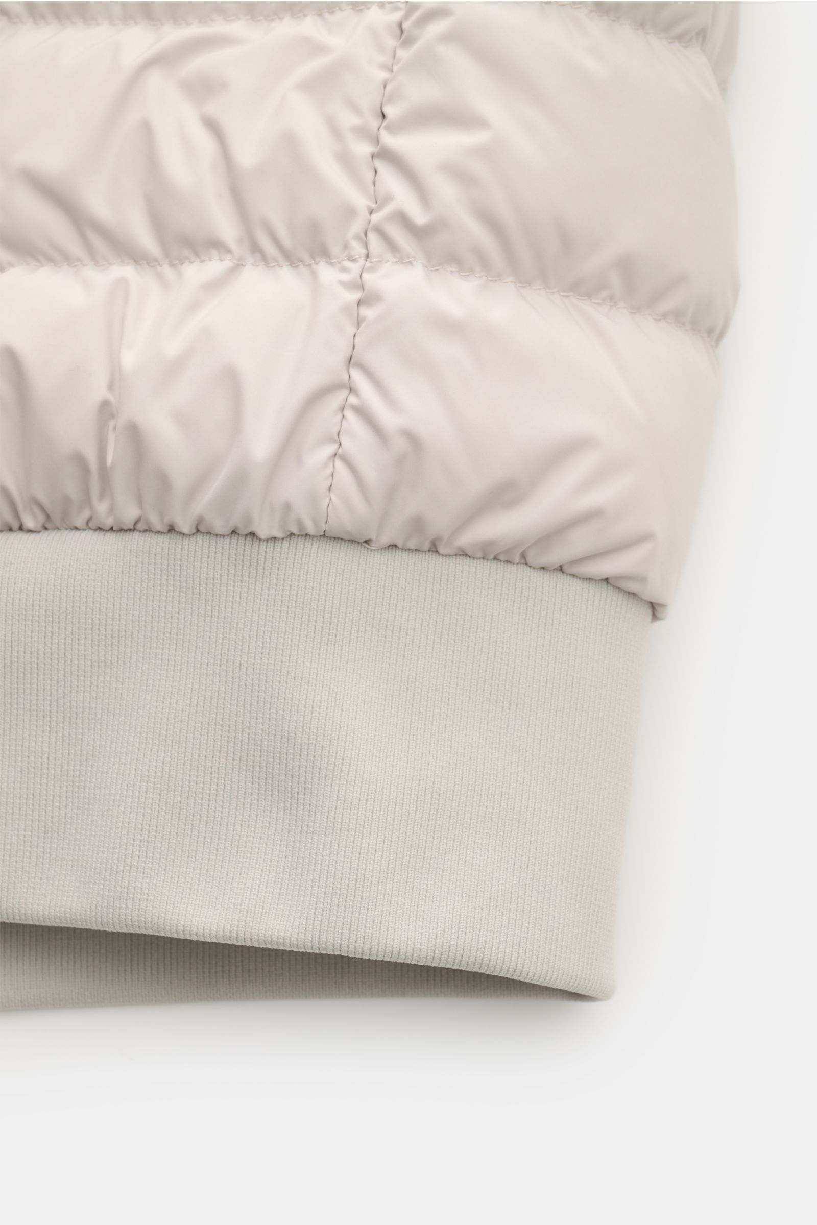 Close-up side view of the rib knit cuff and sand-colored padded fabric of the Parajumpers Down blouson 'Breving' sand, showcasing its high-quality microfibre, smooth feel, and wind and water repellent finish.