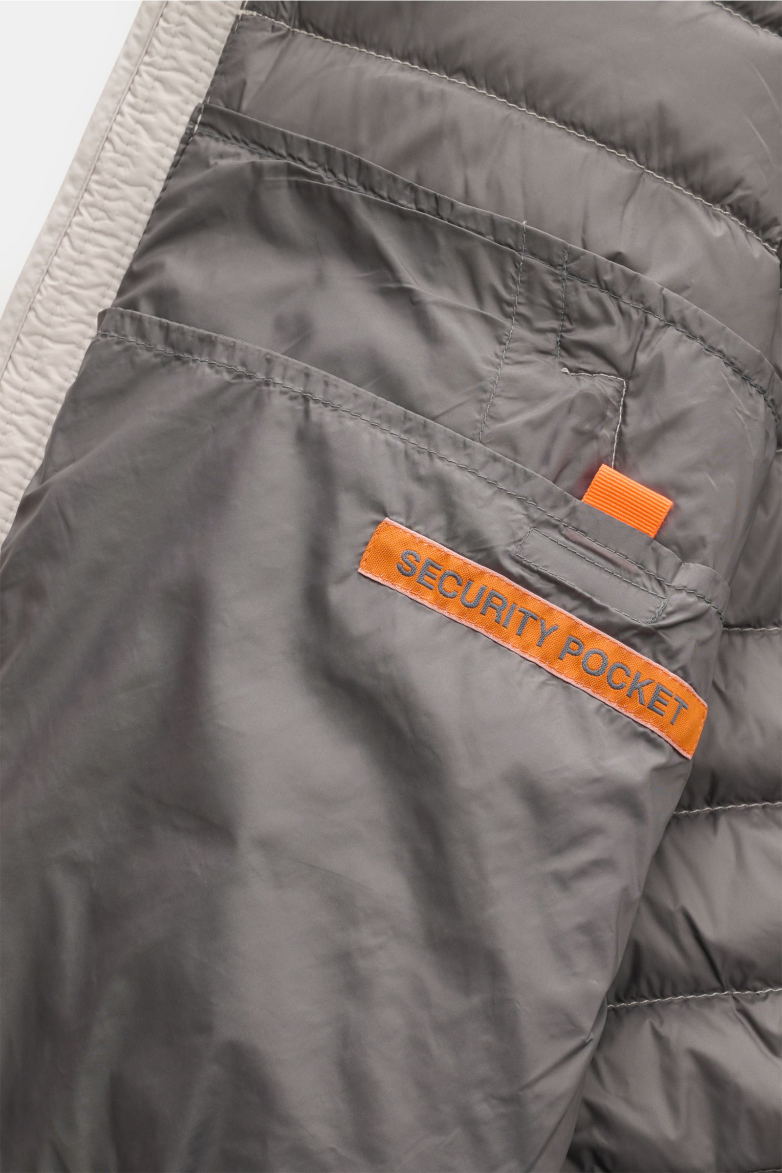 Close-up inside view of Parajumpers Down blouson 'Breving' sand showing gray smooth lining and orange 'SECURITY POCKET' label. Style meets function: This down blouson by PARAJUMPERS keeps you comfortably warm on cold days and is versatile enough to work i