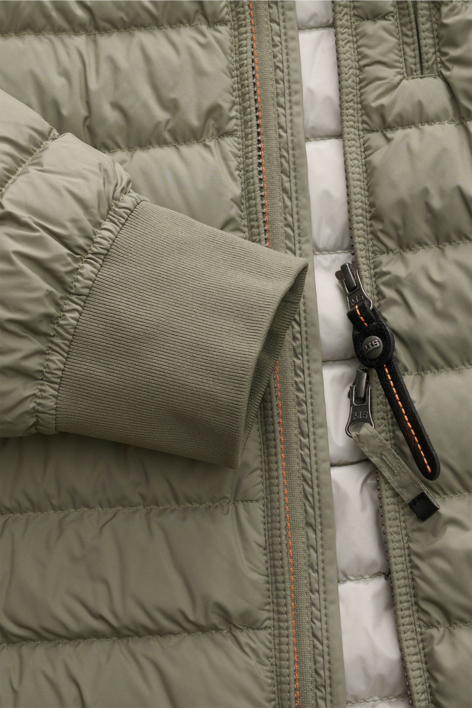 Close-up front view of Parajumpers Down blouson 'Breving' sage showcasing sage green microfibre fabric, rib knit cuff, and two-way zip with black and orange pull tabs. Style meets function: this down blouson keeps you warm with wind and water repellent sm