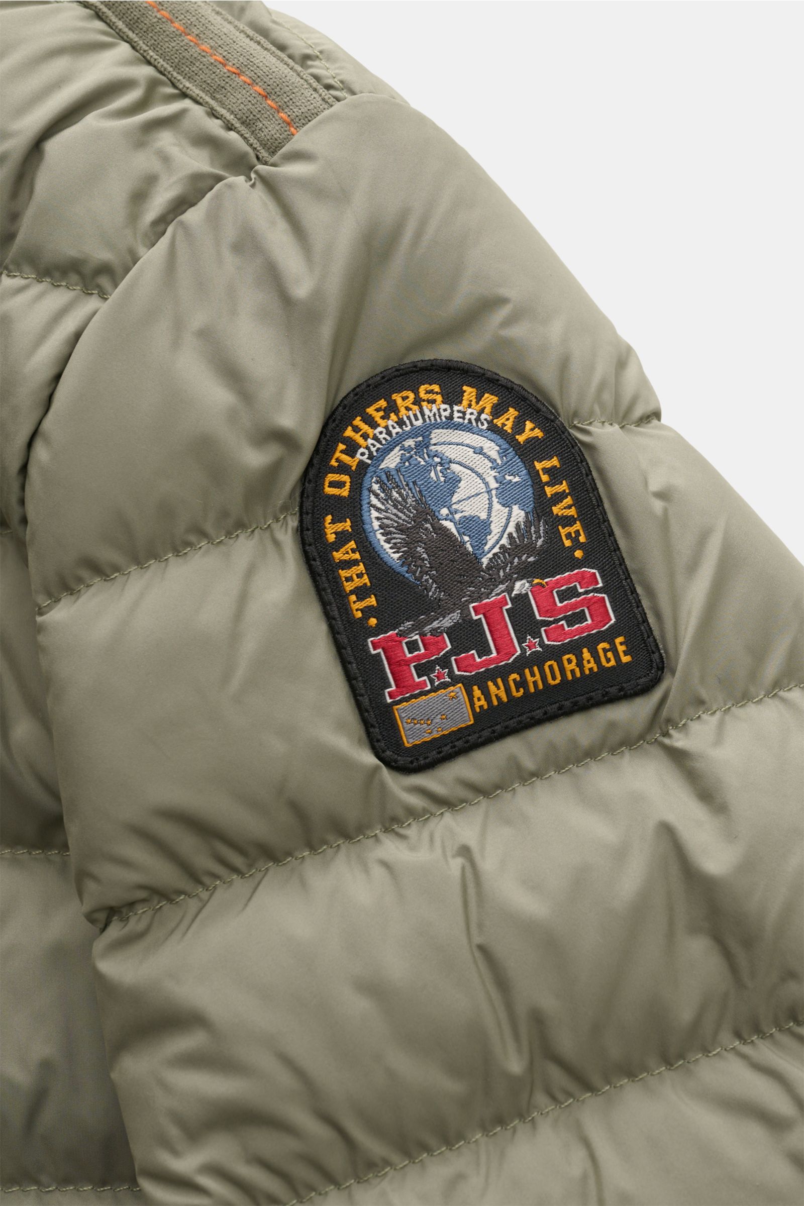 Close-up side view of the Parajumpers Down blouson 'Breving' sage showing the quilted texture and embroidered PJS Anchorage patch on the sleeve. Style meets function: This down blouson by PARAJUMPERS keeps you comfortably warm on cold days and is versatil