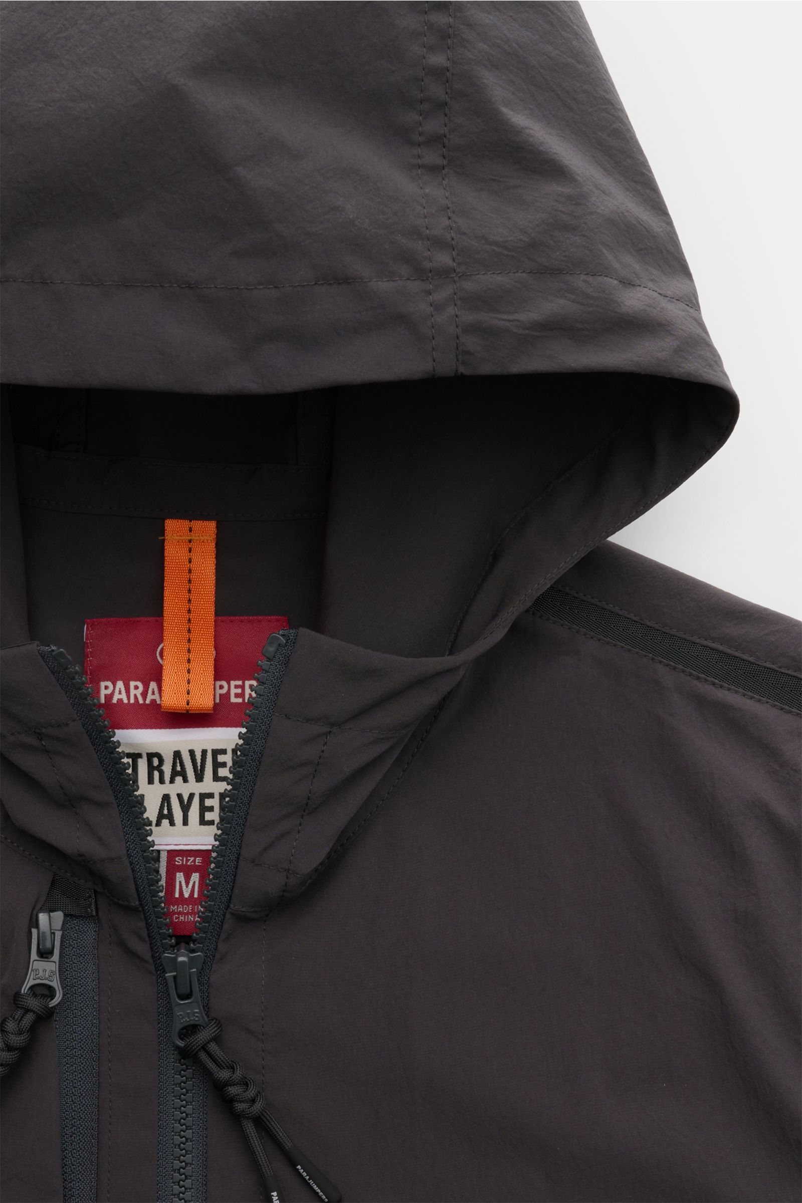 Close-up front view of the Parajumpers Jacket 'Inverness' anthracite showing the hood, two-way zip, and smooth crease-free microfibre fabric. Technical sophistication on the move: The hooded jacket 'Inverness' by PARAJUMPERS has a crease-free surface in s