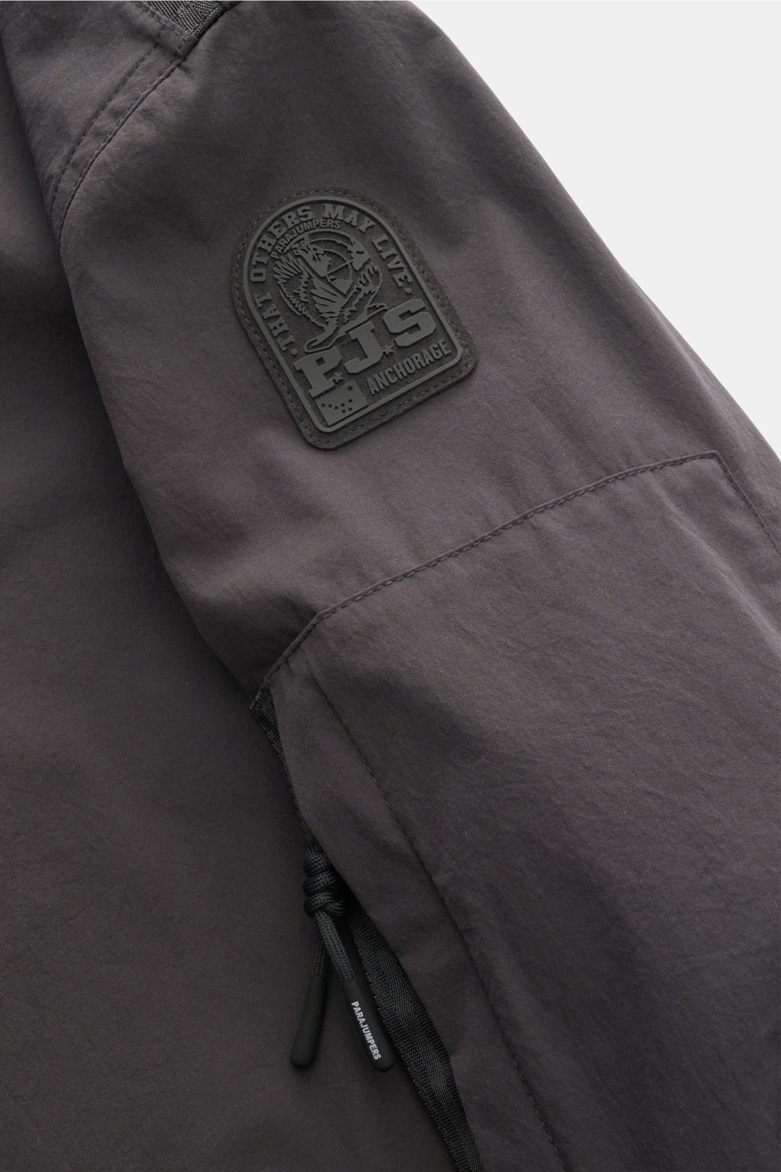 Close-up side view of the Parajumpers Jacket 'Inverness' anthracite showing the smooth, crease-free microfibre fabric, PJS logo patch on the sleeve, and drawstring details; technical sophistication on the move with slim fit, two-way zip, three front pocke
