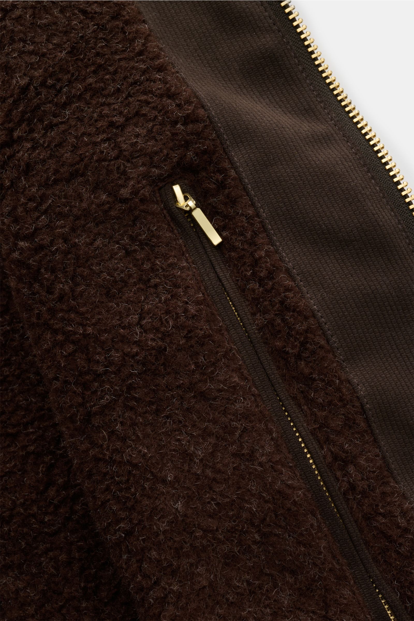 Nahaufnahme der Innenseite der Manifattura Ceccarelli Wachsjacke 'Blazer Coat' dunkelbraun, mit Wollfutter, Reißverschluss und robustem Material.