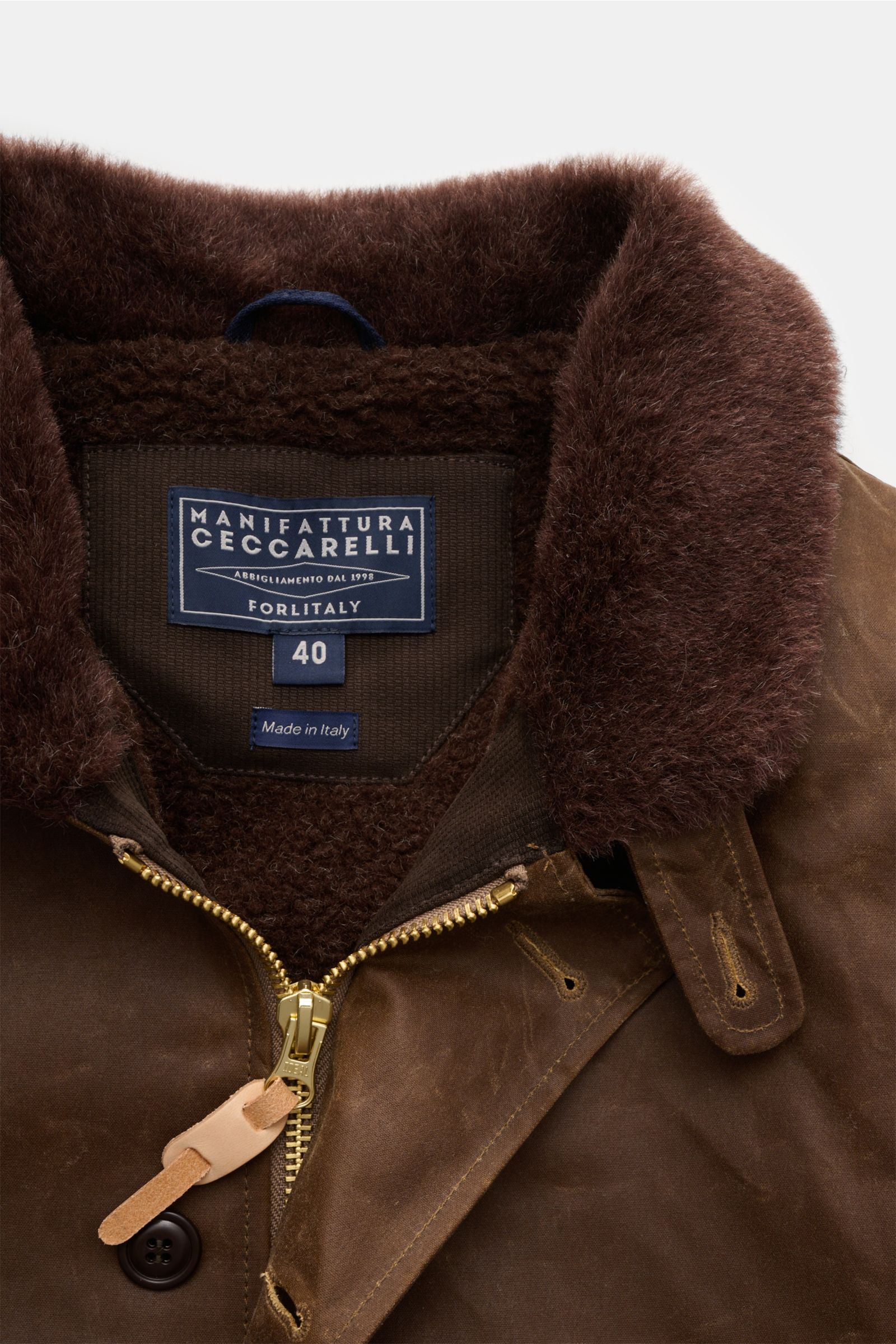 Manifattura Ceccarelli Wachsjacke 'Deck Jacket' braun, Detailaufnahme von Kragen mit Alpakawolle, Reißverschluss und Knopfverschluss.