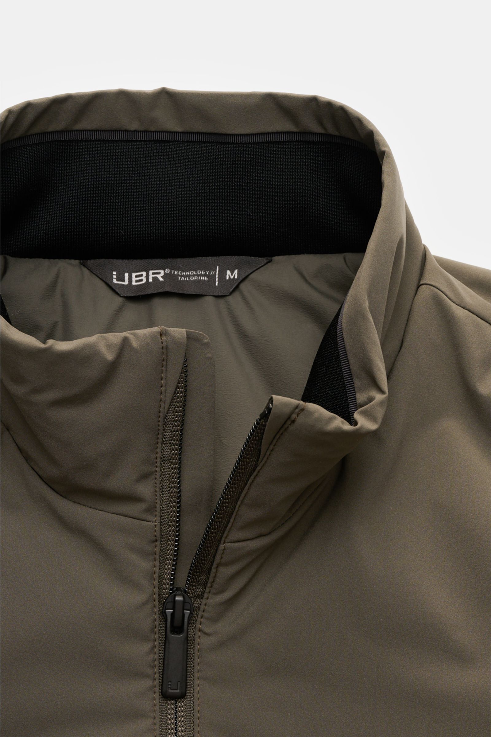 Close-up front view of UBR Jacket 'Viper' grey-green showing high-closing collar, two-way zip, and smooth stretchy microfiber fabric.