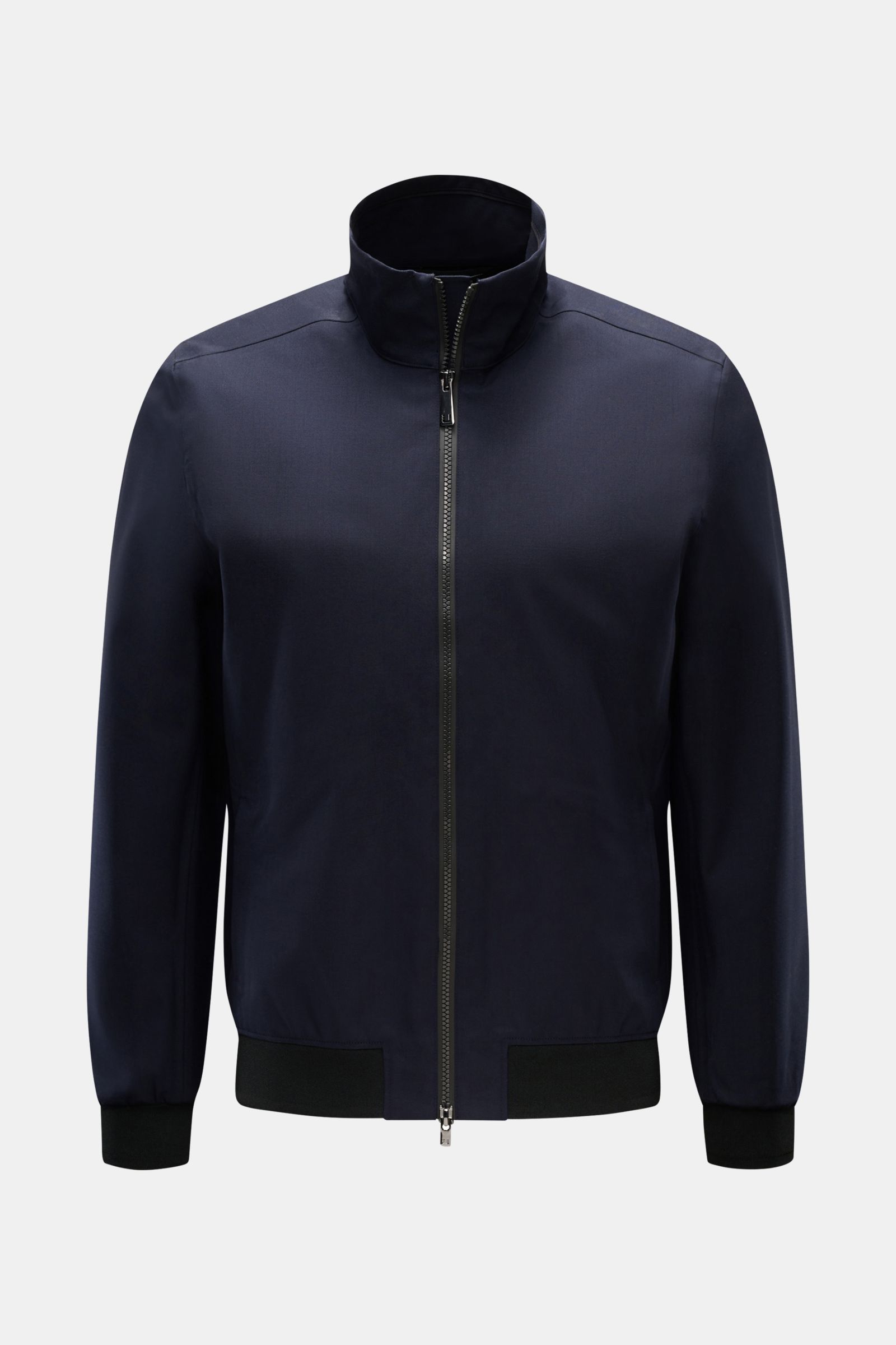 Front view of UBR Blouson 'Bullet Savile' navy, a slim fit, minimalist and functional jacket with fine wool fabric, standing collar, two-way zip, side zip pockets, flexible knit bands, and one inside pocket. Wind and water repellent with sealed seams, mad