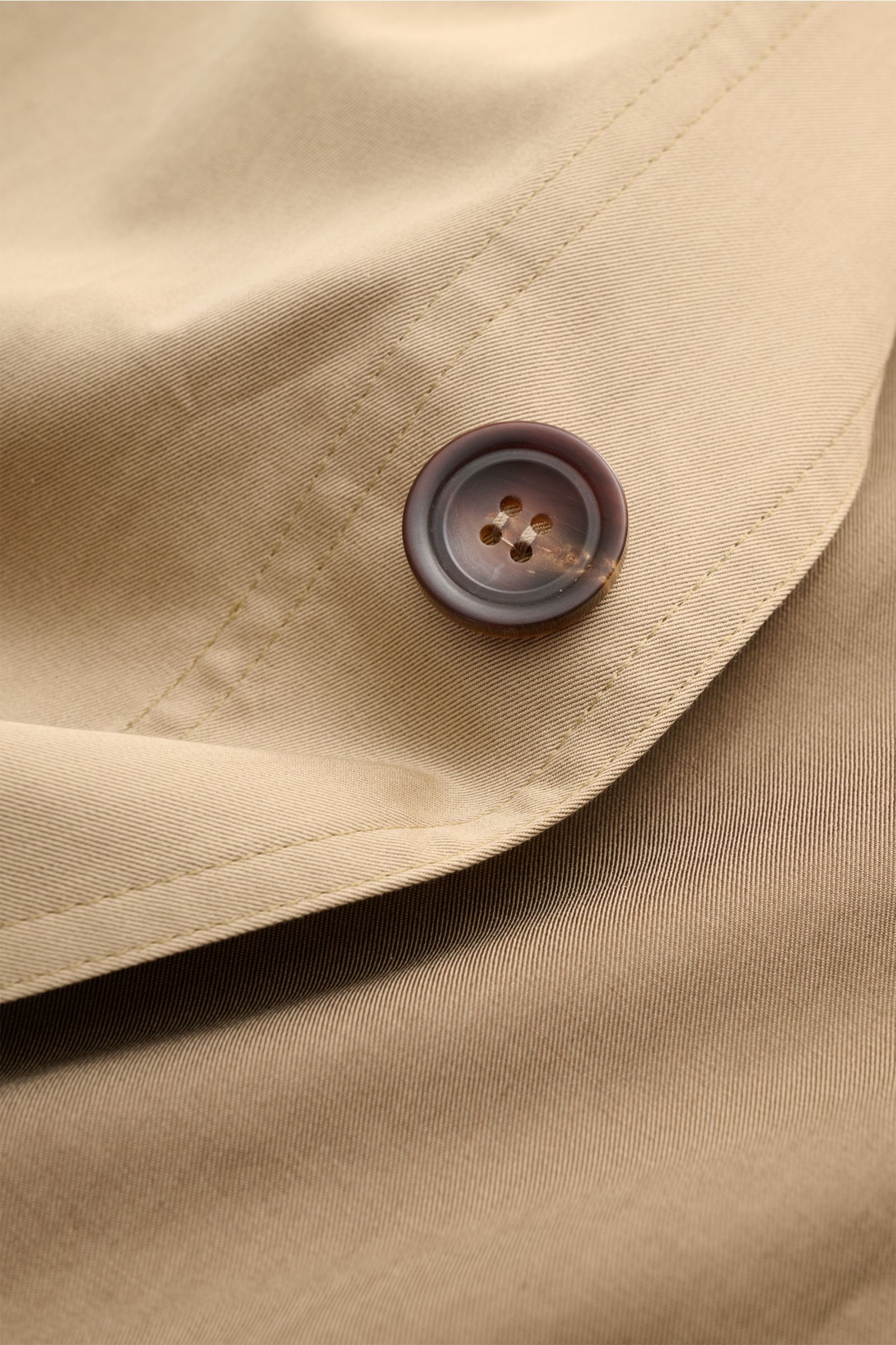 Close-up view of the Doppiaa Overshirt 'Aasti' beige button and fine twill cotton fabric, showing detailed stitching and soft texture. Versatile style for spring and summer: The subtle workwear charm of the lightweight cotton 'Aasti' overshirt from DOP