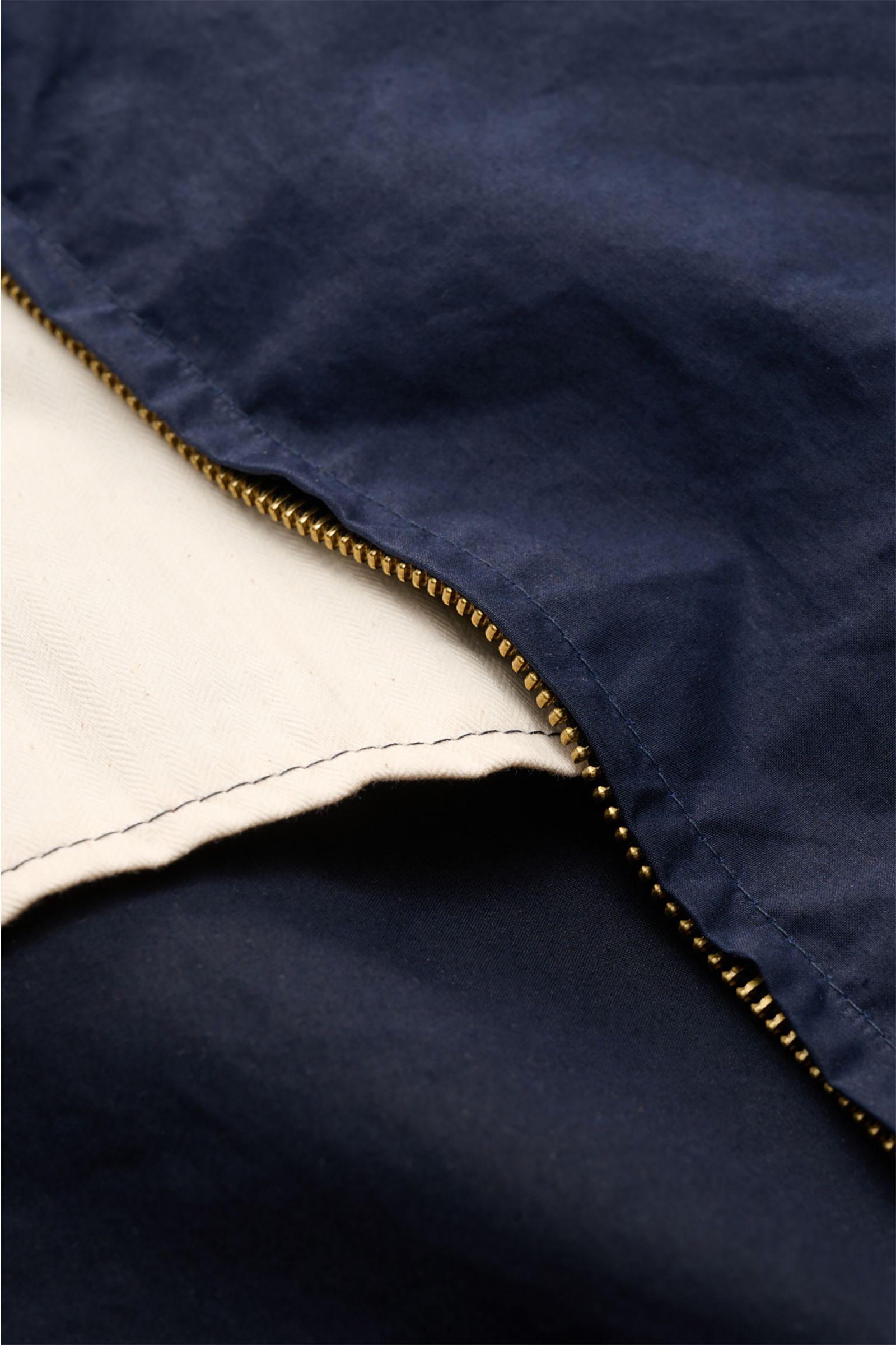 Nahaufnahme der geöffneten Manifattura Ceccarelli Wachsjacke 'Hooded Blazer' navy mit paraffiniertem Baumwollgewebe und robustem Zwei-Wege-Reißverschluss.