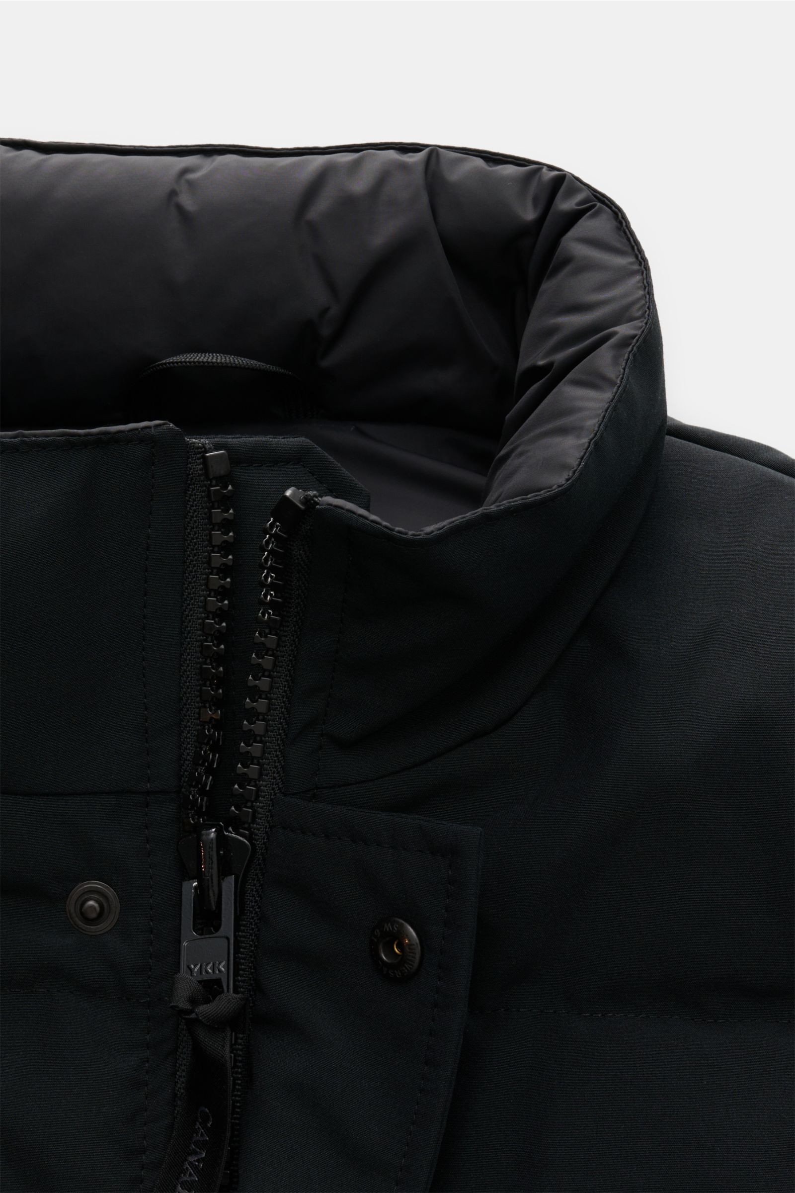Canada Goose Daunenweste 'Garson' schwarz, Detailaufnahme von oben mit wasserabweisendem Baumwoll-Microfaser-Mix, Slim Fit, robustem Reißverschluss und Stehkragen.