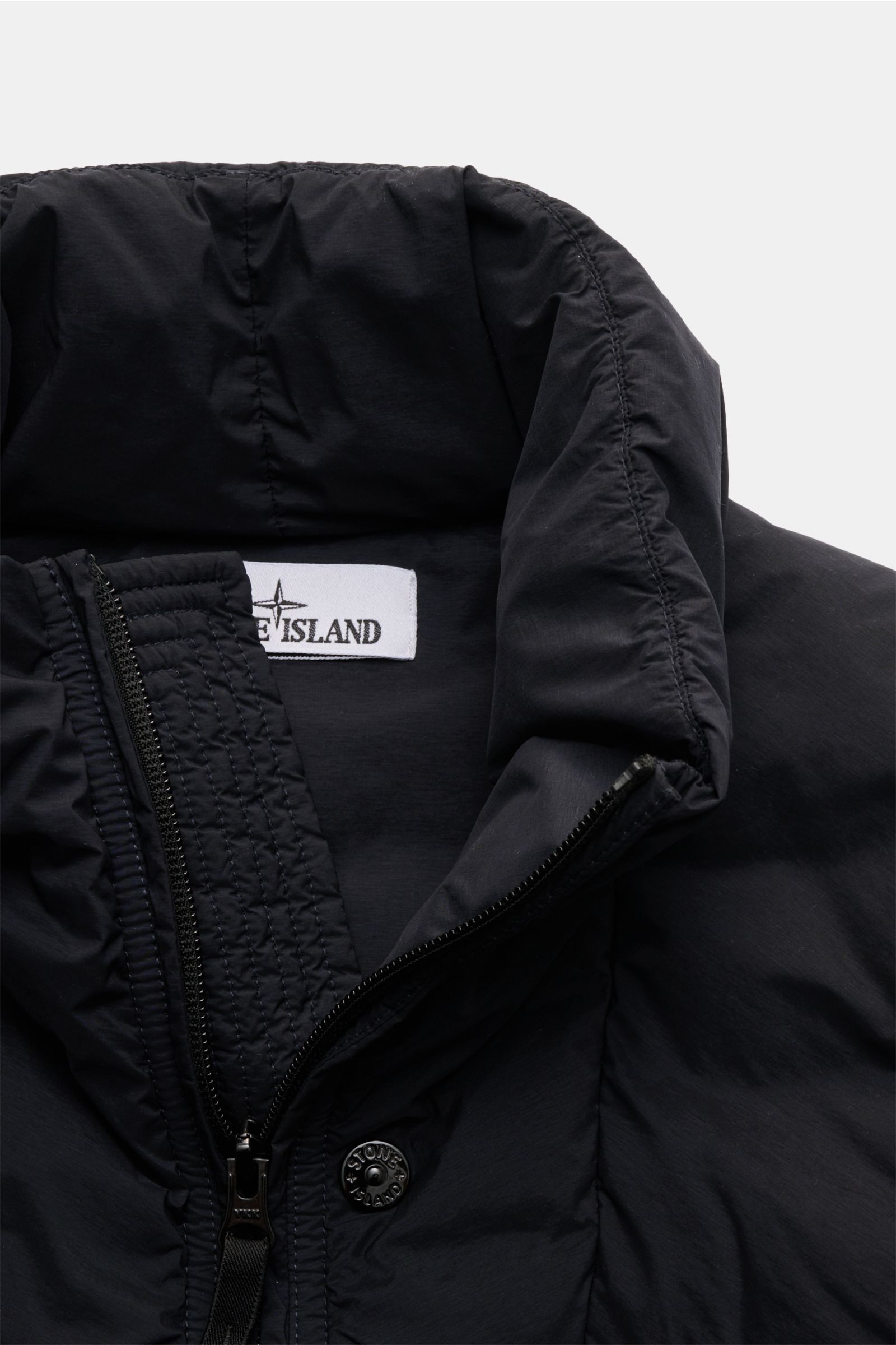Stone Island Daunenweste 'Seamless Tunnel Nylon Down' navy shown from a close-up front perspective, highlighting the padded collar, two-way zipper, and smooth, wind- and water-resistant microfiber fabric with a slim fit design. Innovative outdoor essentia