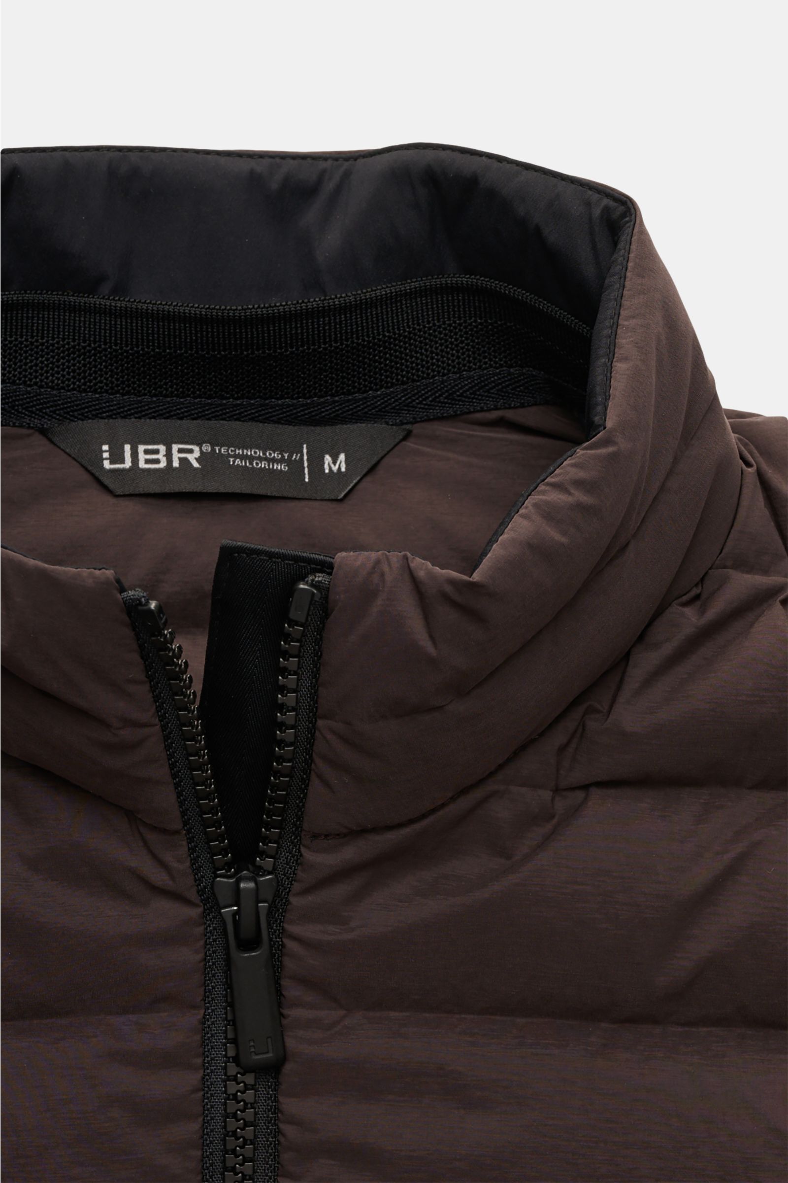 Close-up front view of the UBR Down gilet 'Supersonic' grey-brown showing the high collar, two-way black zipper, and stretchy microfiber fabric with lightweight down lining for warmth and water repellence.