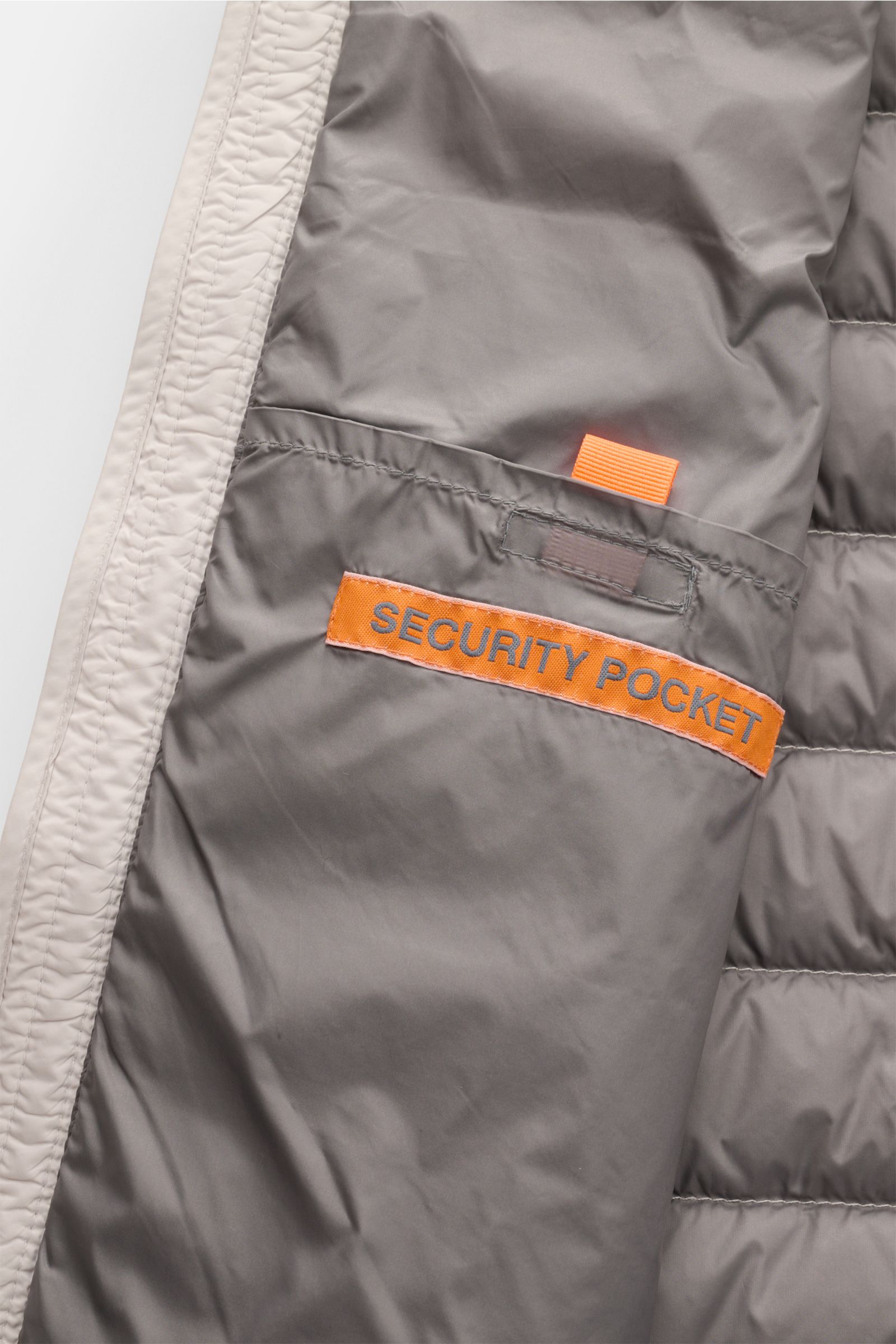 Inside view of Parajumpers Down gilet 'Perfect' sand showing a gray interior security pocket with bright orange label and trim.

Description: The incredibly lightweight and comfortable down gilet 'Perfect' by PARAJUMPERS features a classic design and f