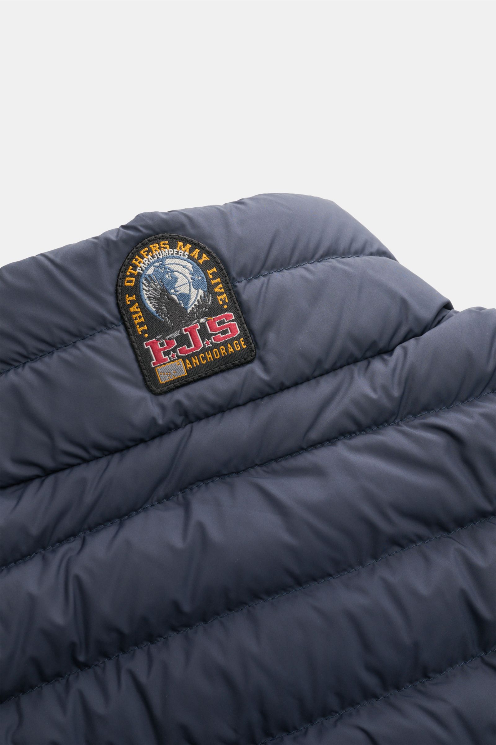 Parajumpers Down gilet 'Perfect' navy shown from a close-up rear angle, highlighting the PJS Anchorage patch on lightweight quilted fabric. 

The incredibly lightweight and comfortable down gilet 'Perfect' by PARAJUMPERS features a classic design and f