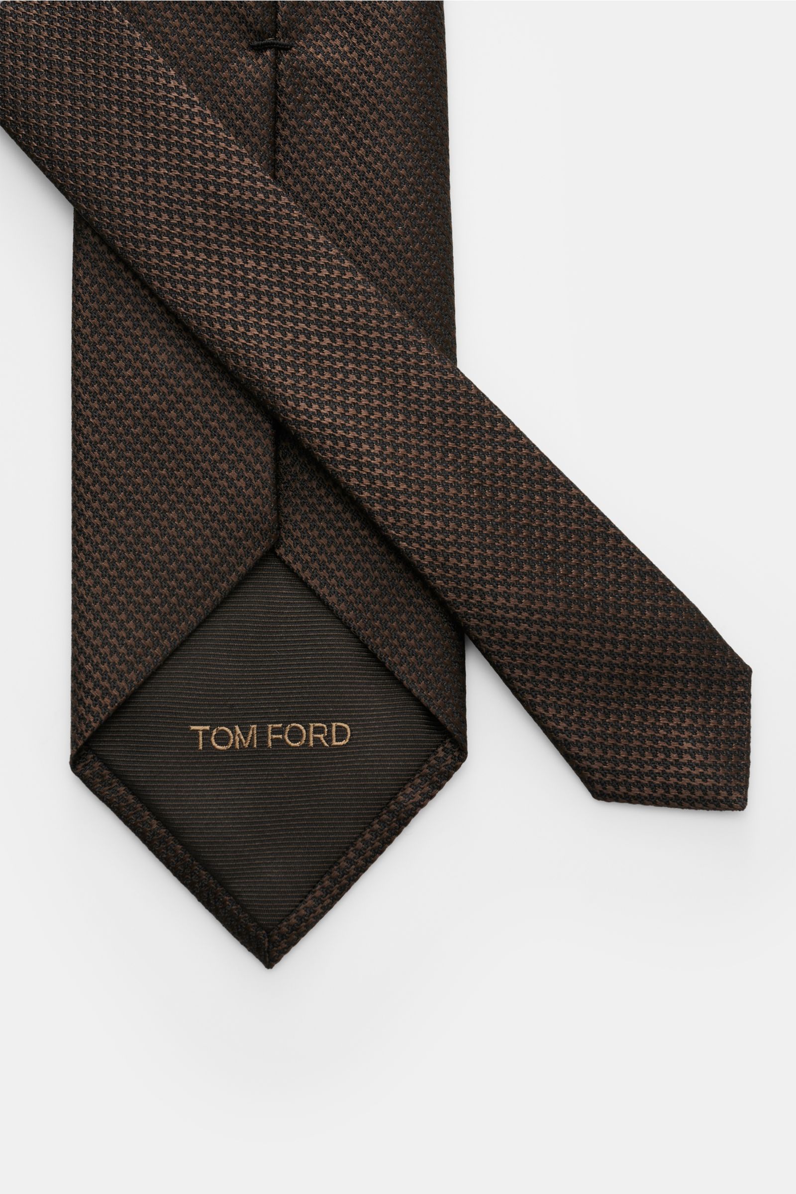 Tom Ford Seidenkrawatte dunkelbraun/schwarz gemustert, Hahnentritt, reine Seide, dezenter Glanz, Logo-Stitching, 8 cm breit, seitlich fotografiert.