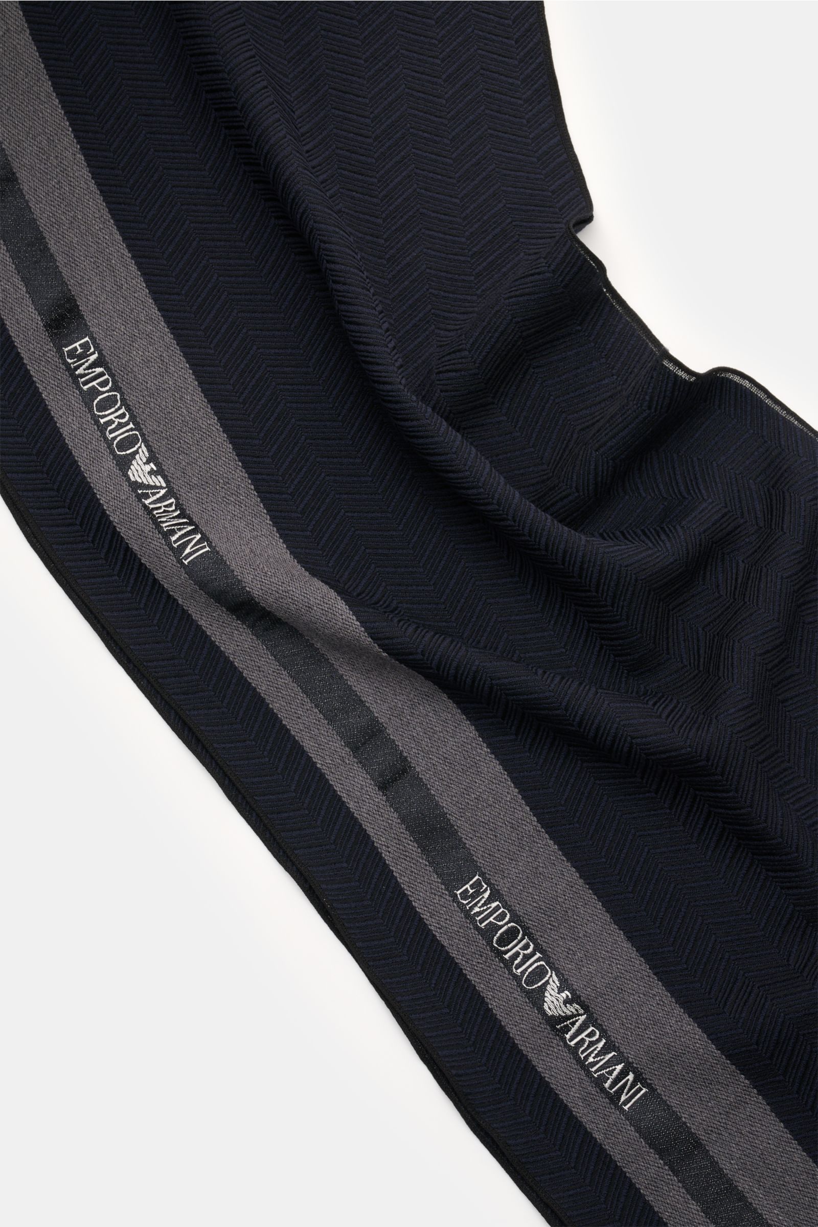 Emporio Armani Schal navy/schwarz/dunkelgrau aus Wolle-Seide mit feinem Webmuster, breiten Kontraststreifen und Web-Logo, schmaler Fransensaum, Ansicht von oben.